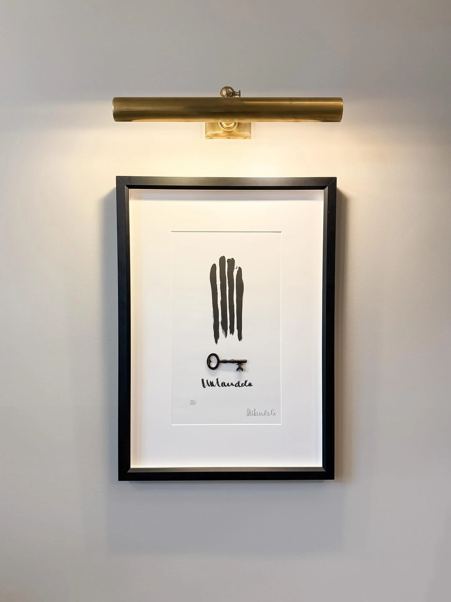 My beautiful @houseofmandelaart piece, created and signed by Madiba himself, finally has a deserving home. The finger-drawn re-creation of the bars of his prison cell with the replica of his actual cell&rsquo;s key made my breath catch in my throat t