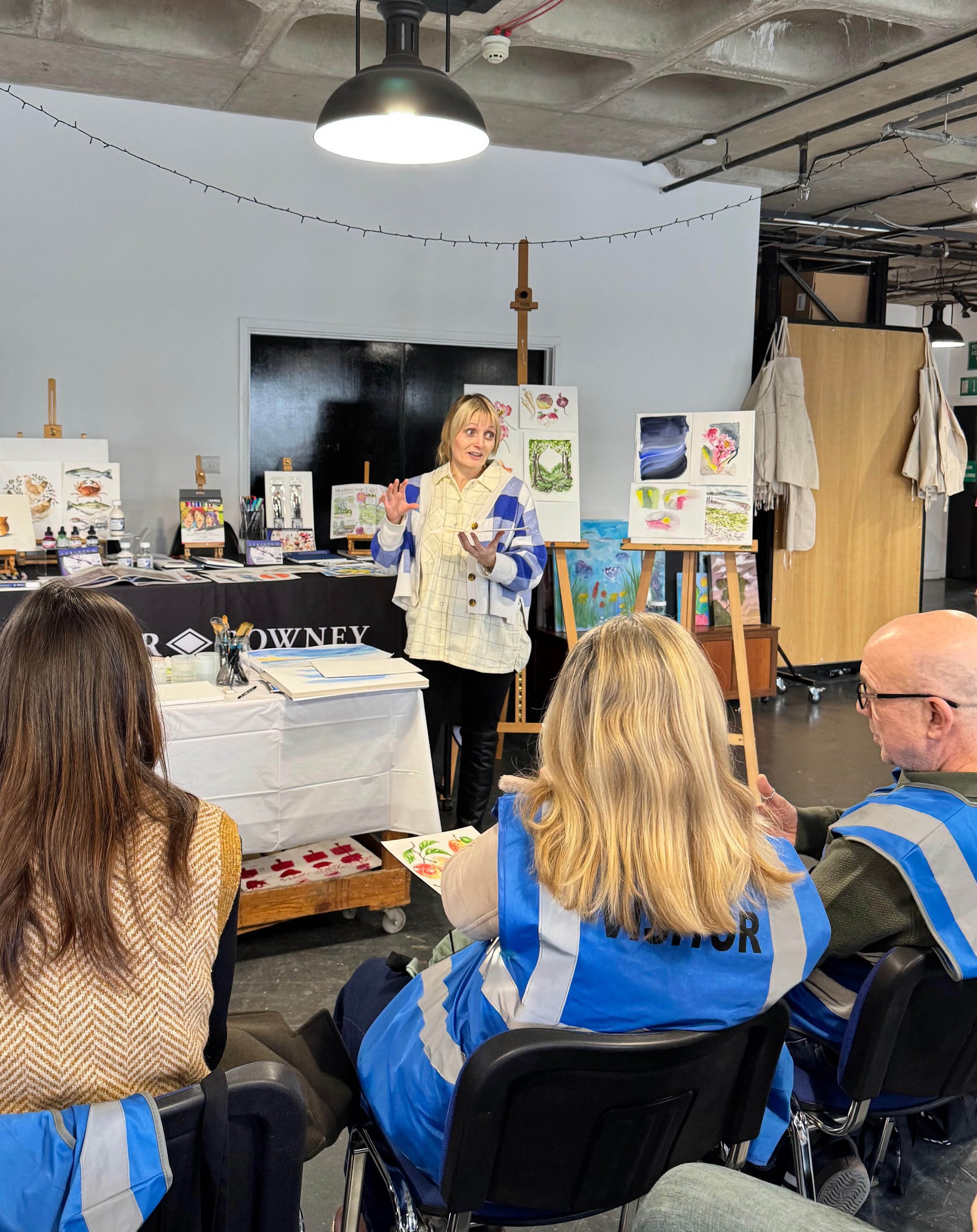 Artist demonstrating professional watercolour techniques using Aquafine paints