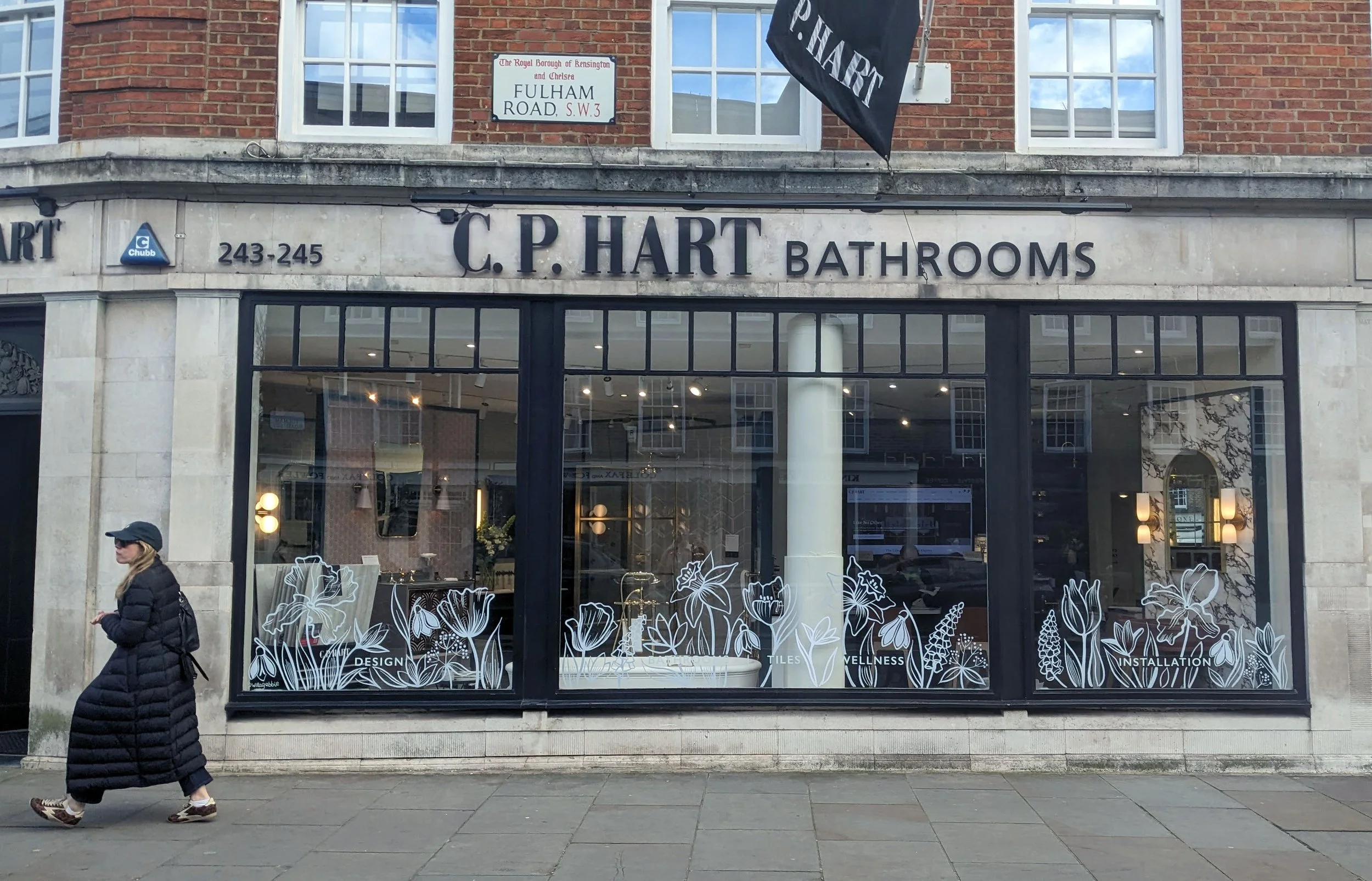 Window painting created by window painter, Willa Gebbie featuring springtime flowers