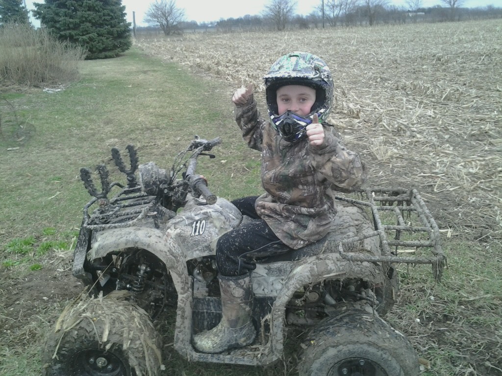 Braedan out Mudding on his 4-wheeler. One of his favorite things to do out doors.