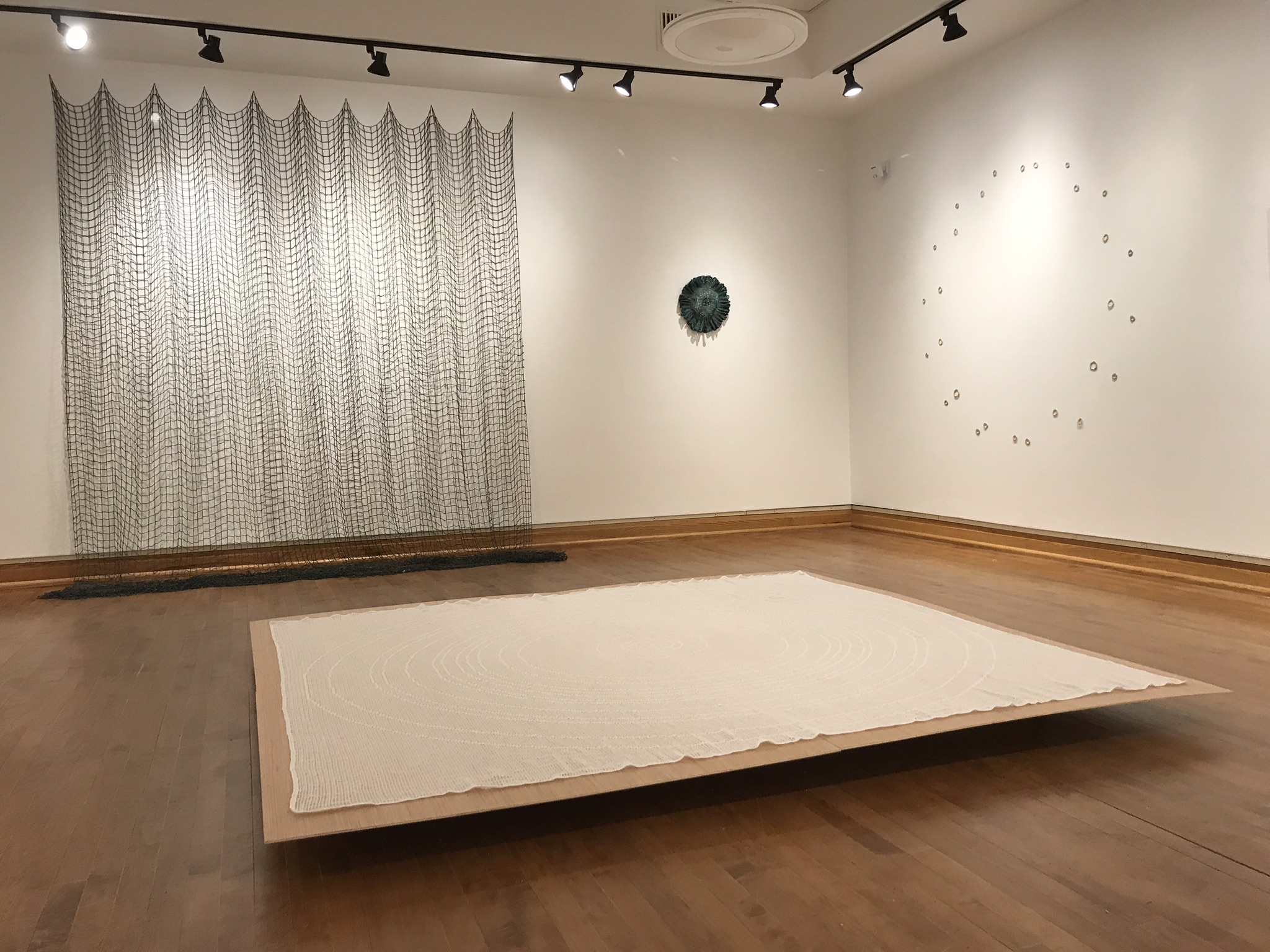 Left to right on wall: Exponent, Part 1 , Pi Model , Orbit . Floor: Poles
