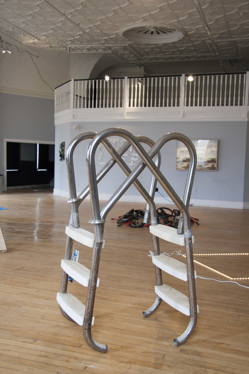 Installation view of Thank Me Ladder, 2014, by Kristina Banera (front) at Junkhaus 1. Exhibition features work of Alex Atteah, Kristina Banera, Hannah Doucet, Jessica Evans, John Patterson, Daniel Romphf, and Rachael Thorliefson.