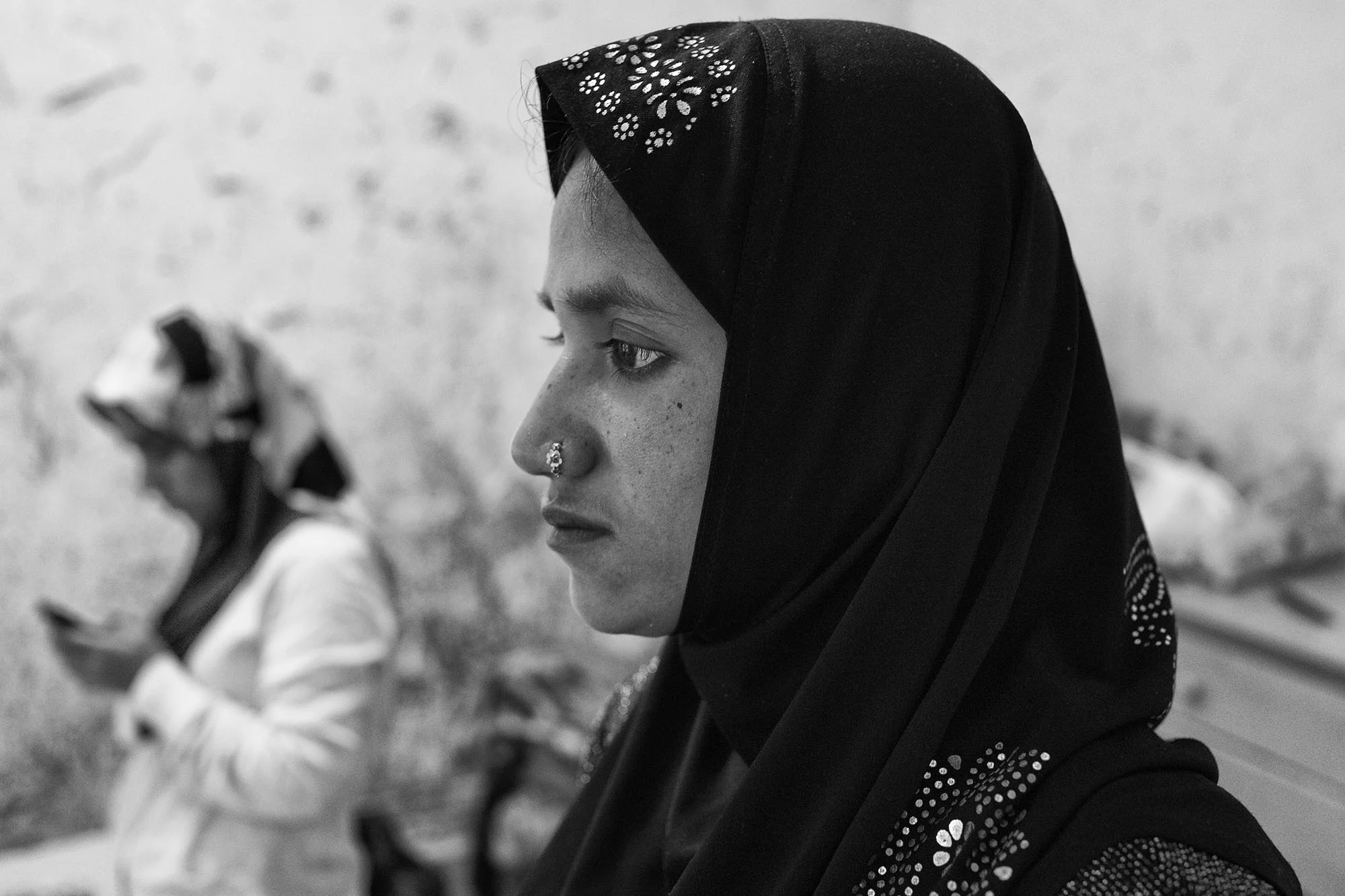 Laila Begum, 28, sits in her new apartment in Chicago. In 2013, she fled her village in the middle of the night, boarding a small fishing boat on the river, as word of an imminent government-led attack spread. She left behind her parents. Her father would not survive. 