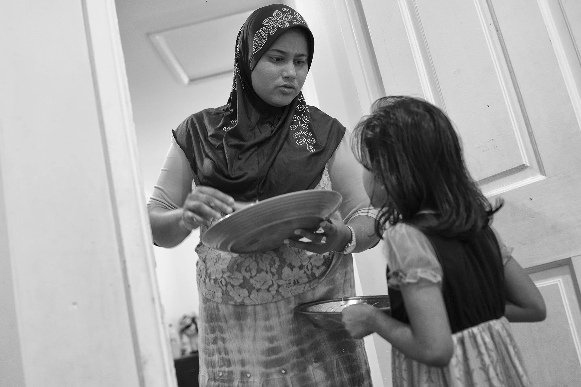 Kulsuma Begun Mdkorim and her two daughters, Lala and Nurkido, fled Myanmar in 2012 after reports that a violent Burmese military group was approaching her village. She was pregnant with her third child, a boy to later be named Kawnaig. They took a small fishing boat to Bangladesh, which cost 700,000 kyat (or approximately $522). Her sister, who was already in Bangladesh, paid for the journey. The plan was to travel to Malaysia to join her brothers. Her husband, who had stayed in Myanmar, was to meet her there.