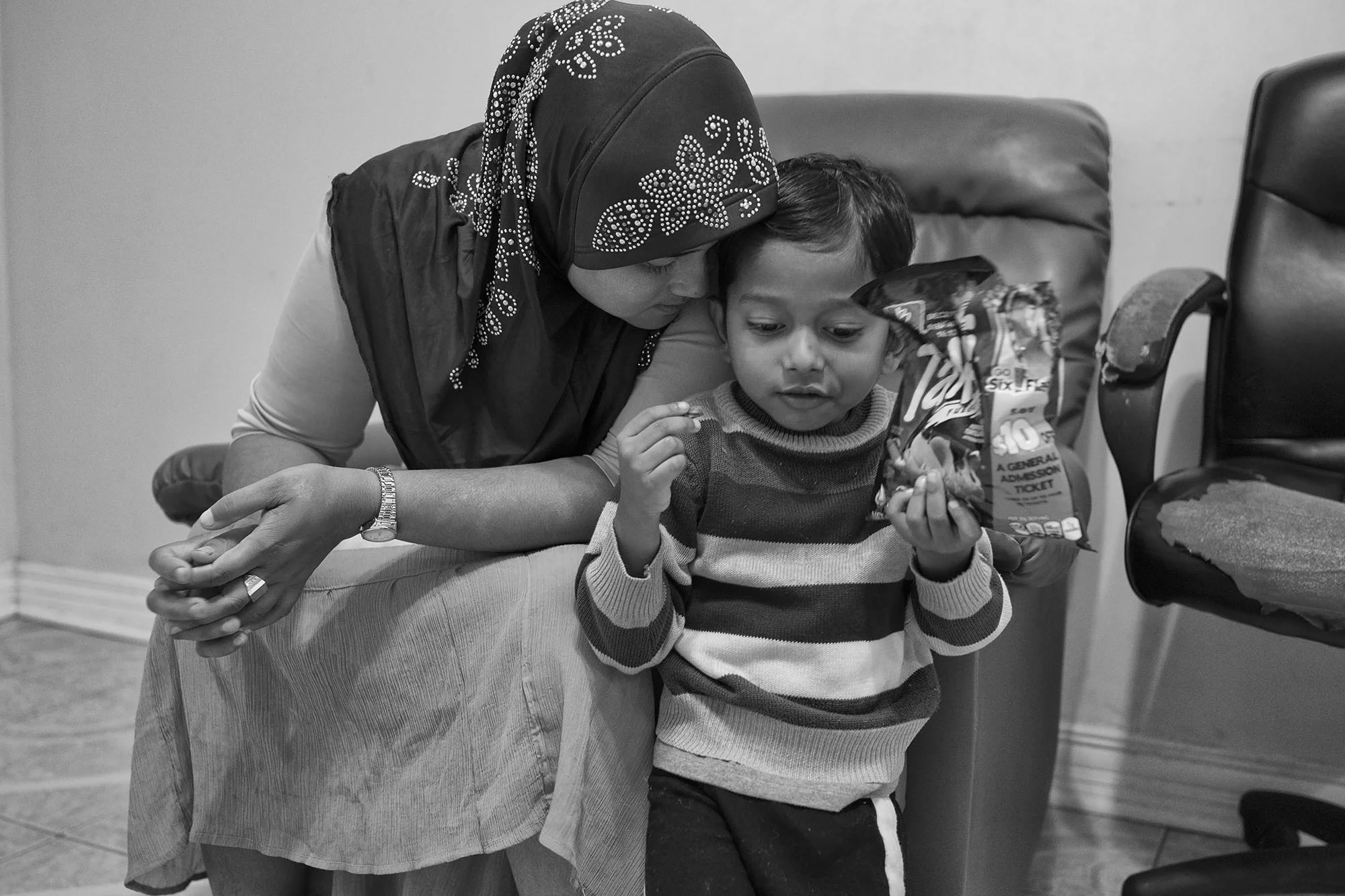 Kulsama snuggles with Kawnaig. Upon arriving to Thailand, pregnant Kulsama and her children spent two days hiding in the jungle while her smugglers tried to extort more money from her brothers, who were expecting her in Malaysia. The Thai police picked them up on the second day and brought them to a detainment camp where they would spend the next year and a half. When she managed to call her village, she was informed that her husband had gone missing along with several other men. All are presumed dead.