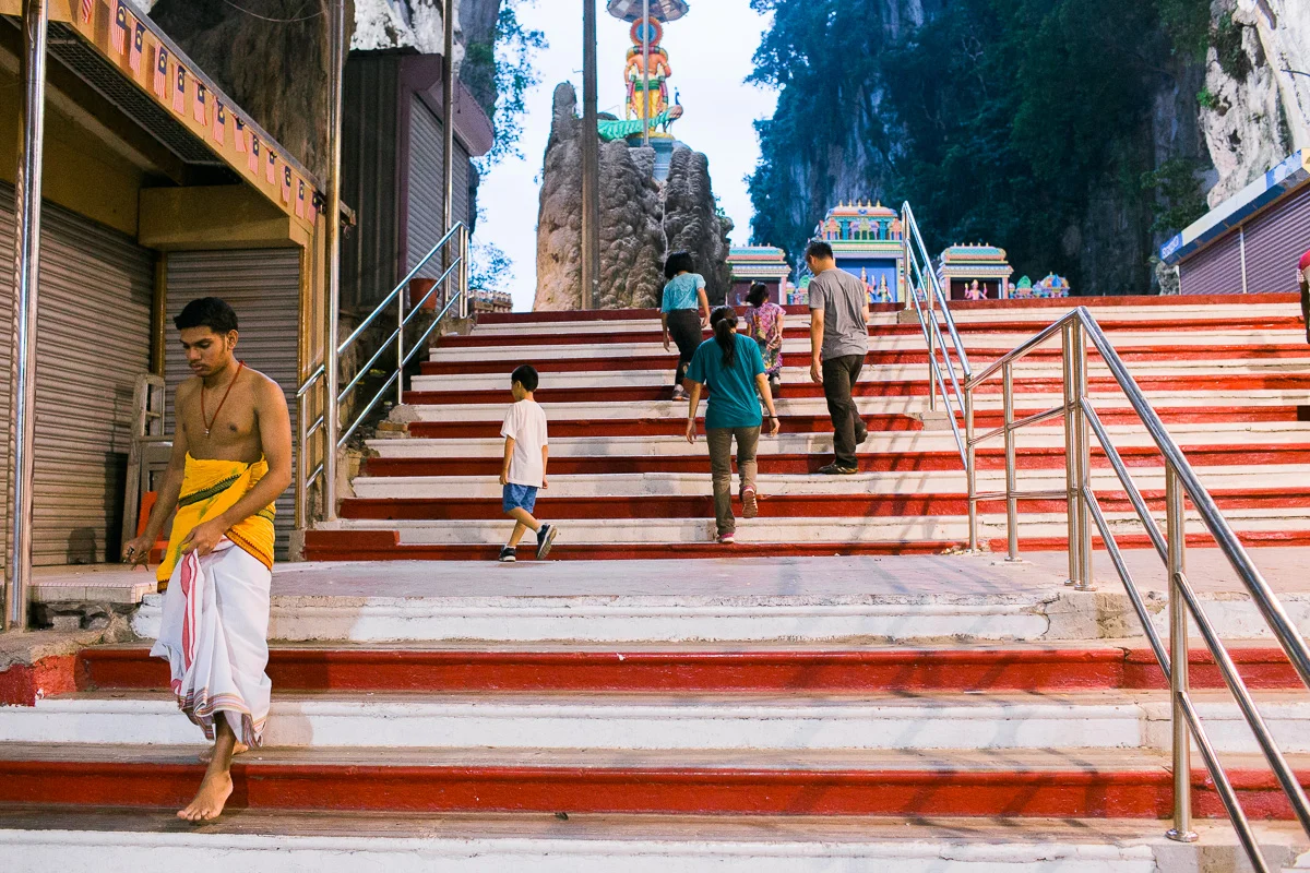 A worshiper descends the steps at Batu Caves.