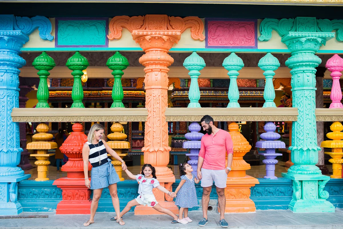A family portrait in front of a colourful temple in Kuala Lumpur.