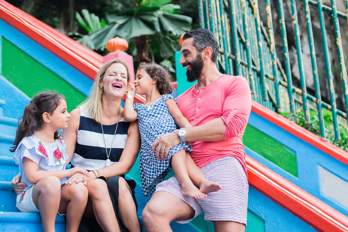 A family plays together on the steps of Batu Caves by KL photographer Erica Knecht