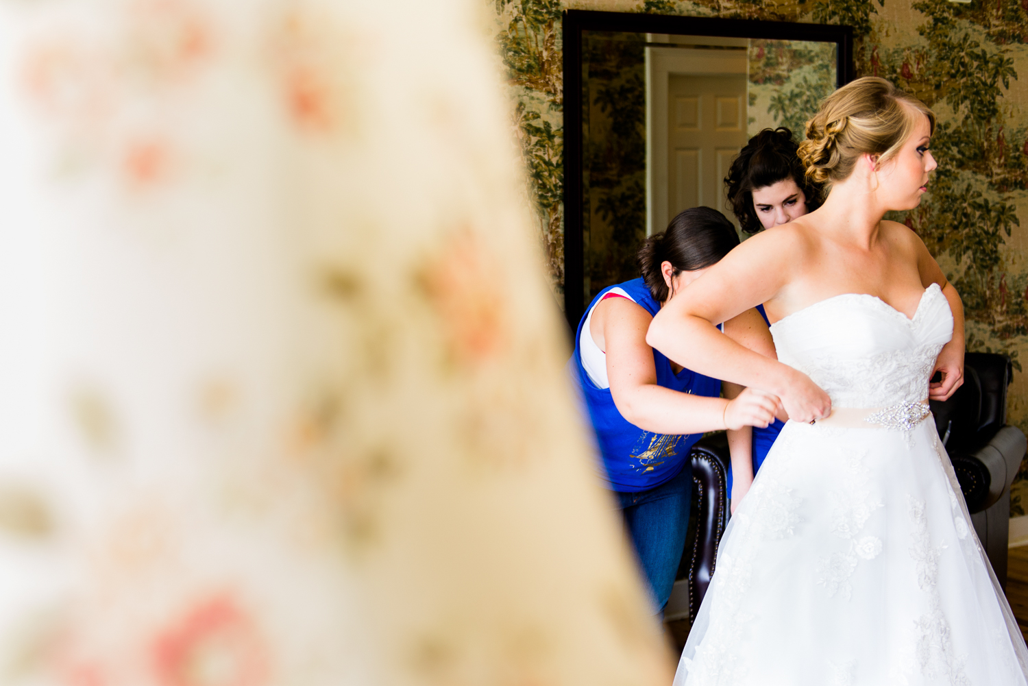 Bride putting on dress