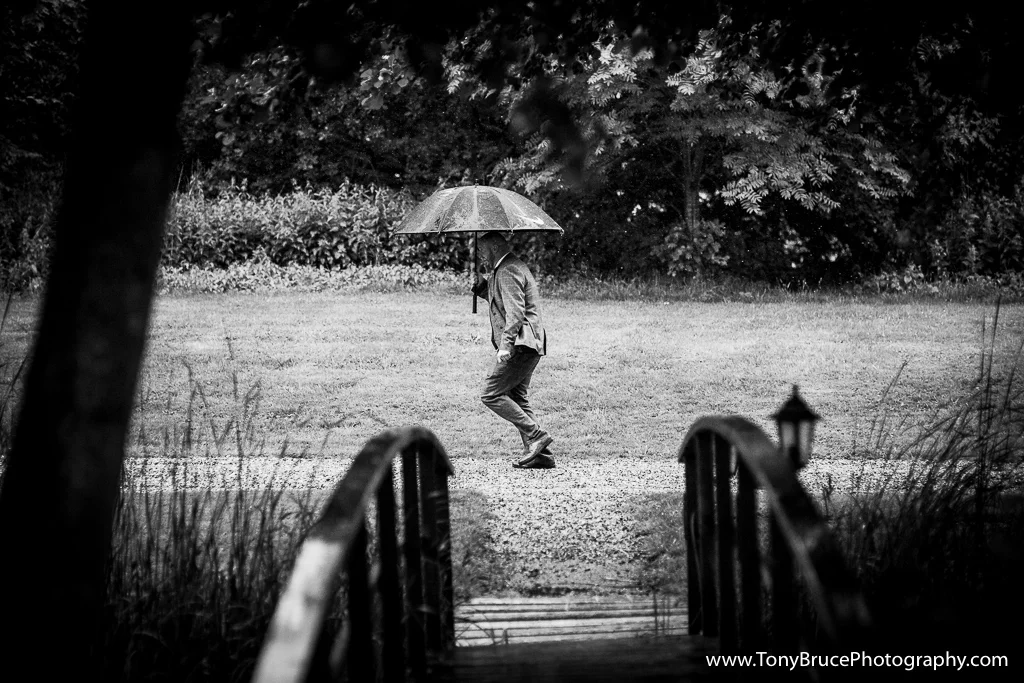 One of the groomsman dashes for his car in order to collect the Bride and her party as the heavens opened.