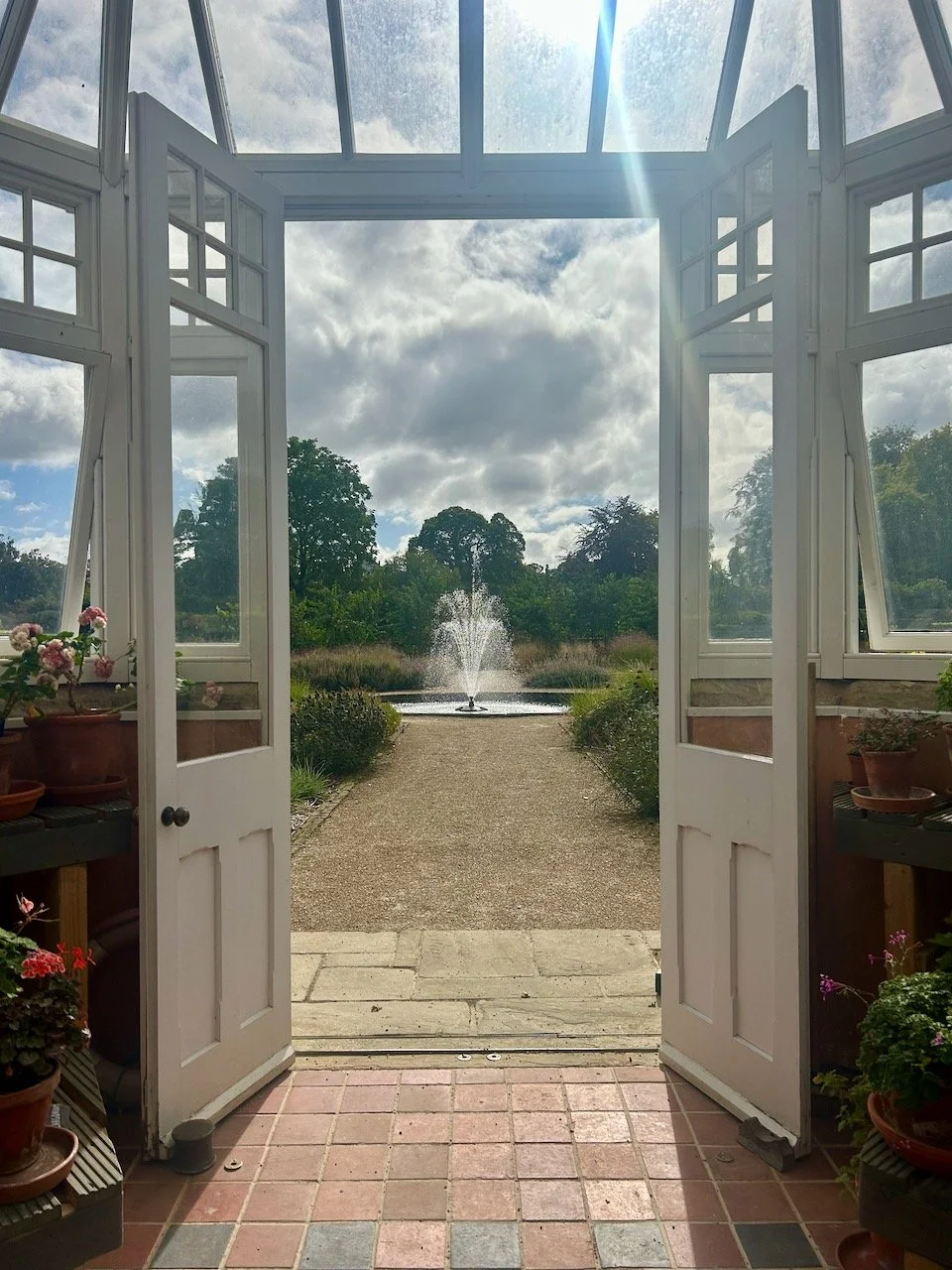 Looking out of the conservatory to the central fountain in the garden (and a cloudy sky!)