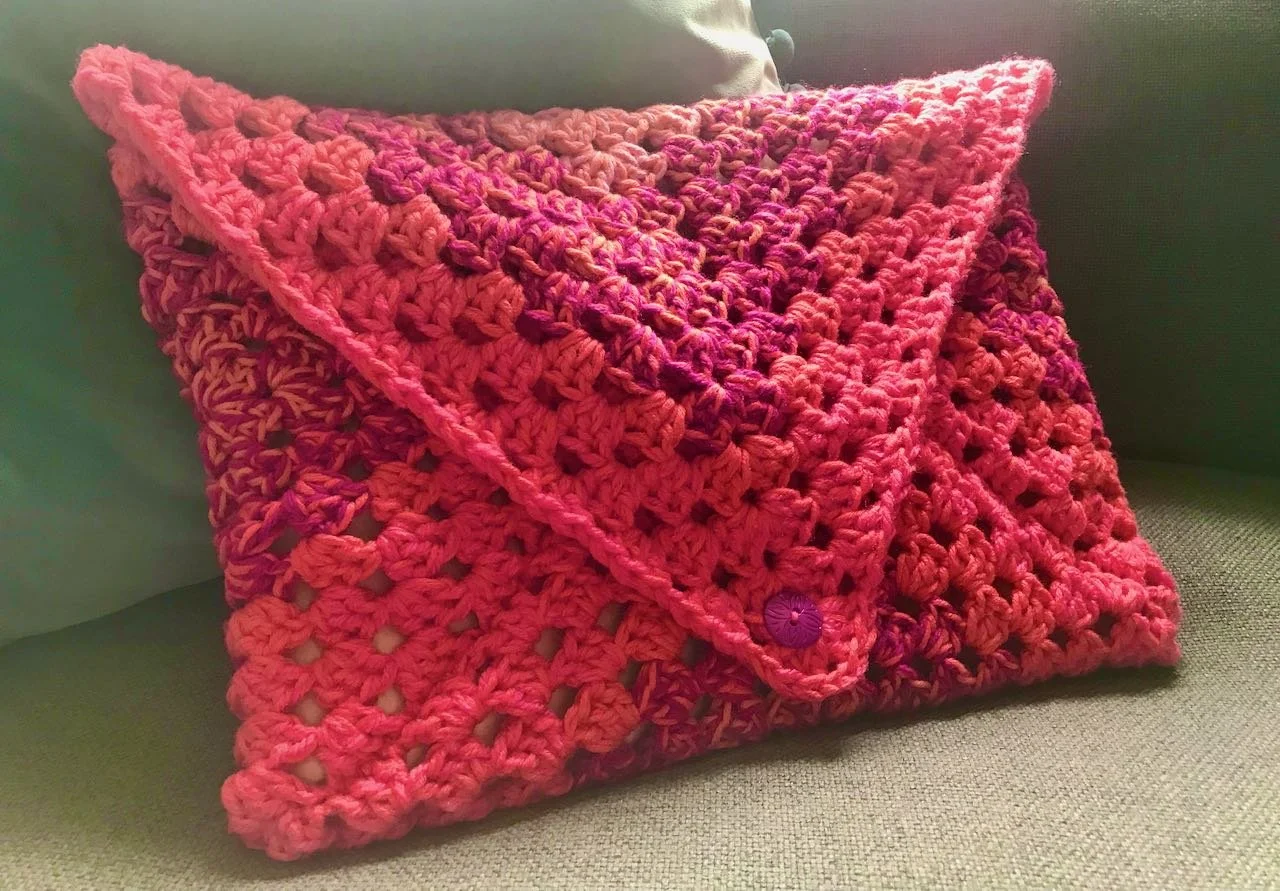 Sewn together and a button added - a granny square envelope laptop cover