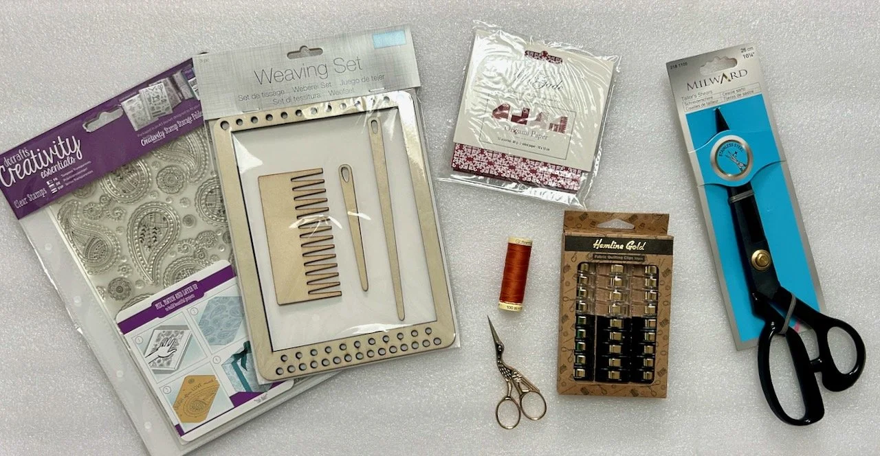 Paisley stamps for papercraft, a small weaving set, origami paper, a reel of cotton, stork scissors, sewing clips and soem shears