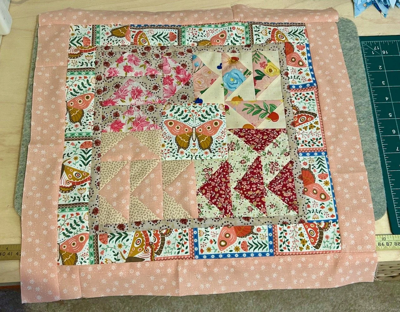 Adding borders to the block - some with butterflies and a finishing with a calming pink floral fabric