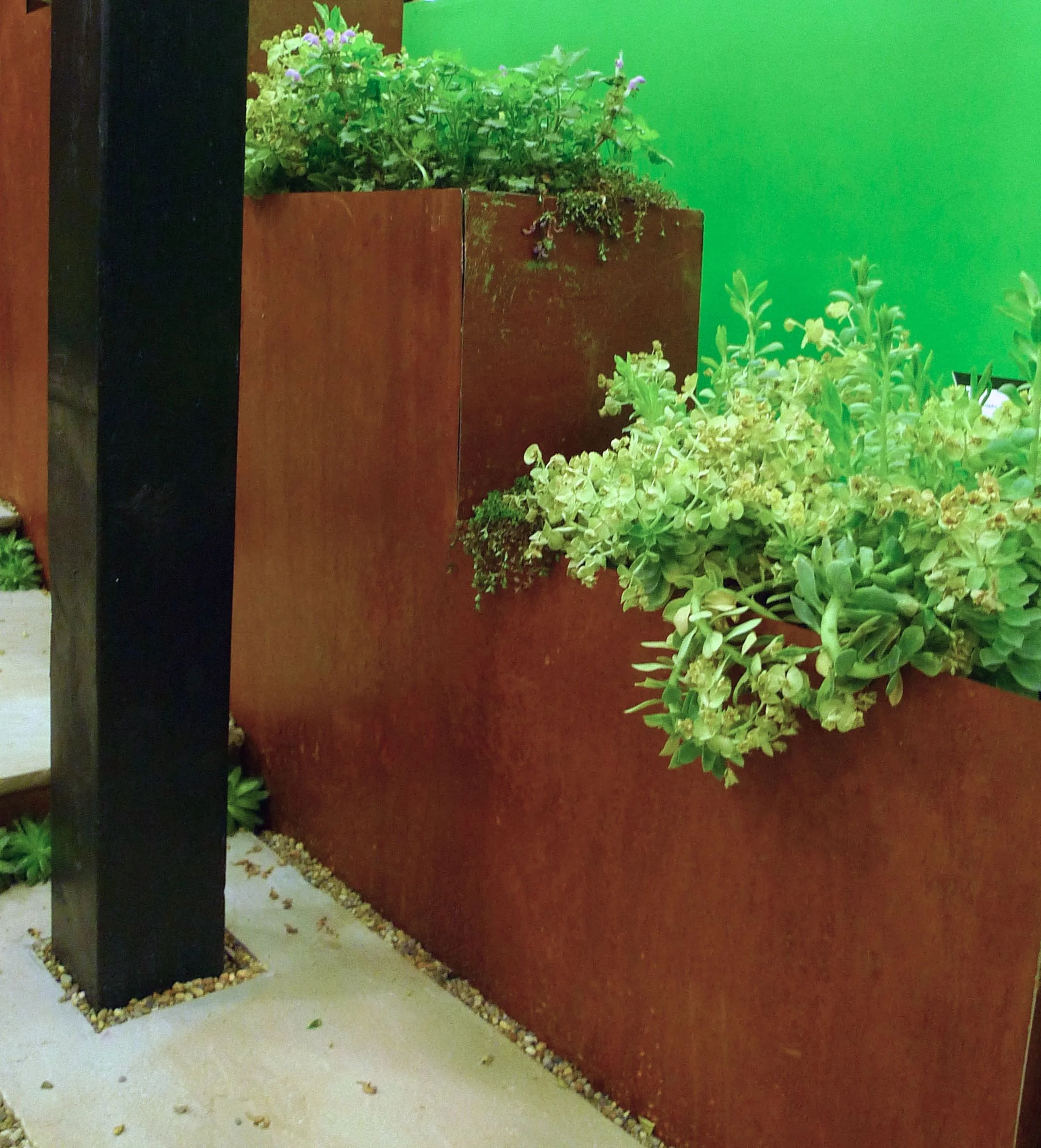 Three of the six show gardens at the Ideal Home Show