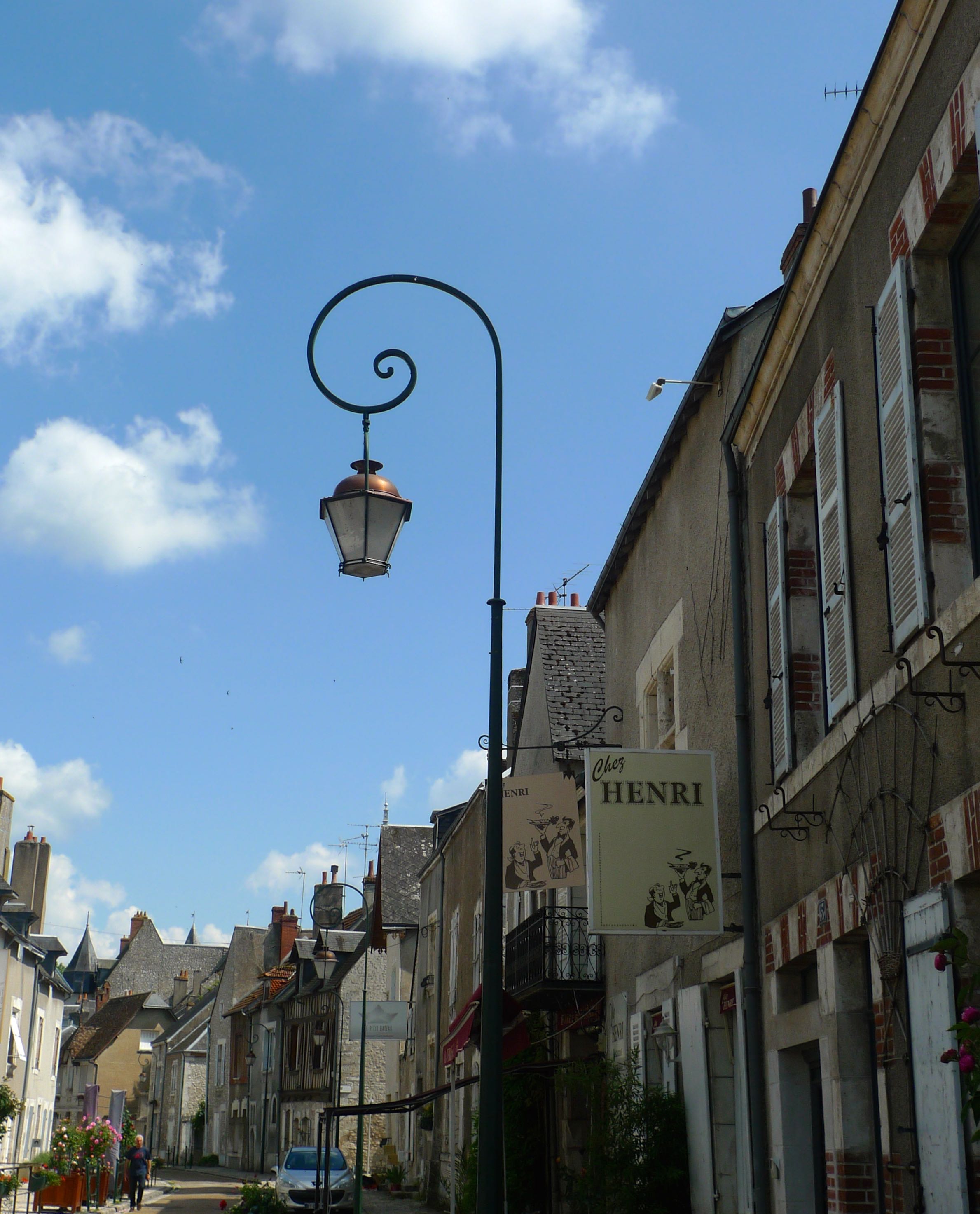 A lamp post with a curl