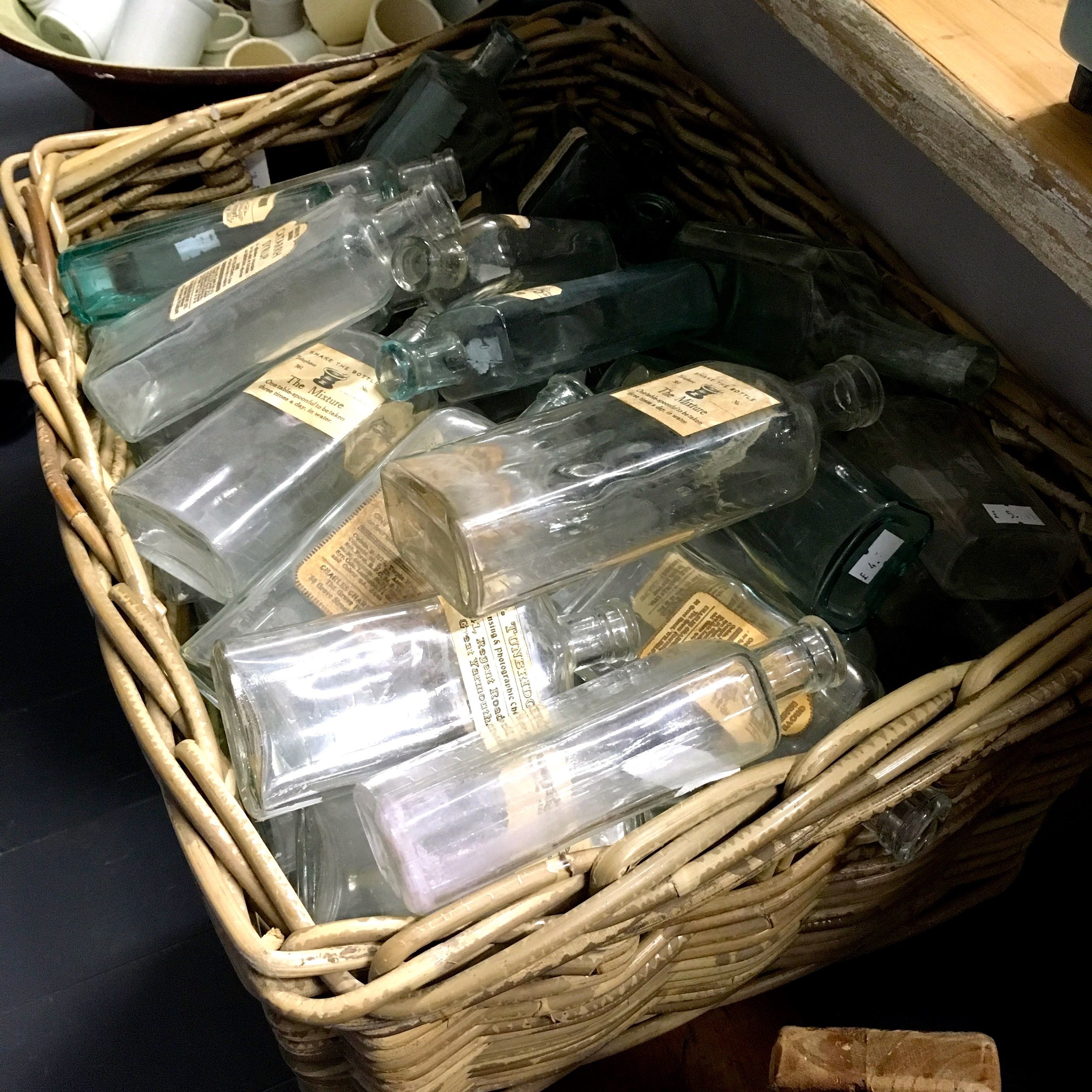 wicker baskets full of old medicine bottles