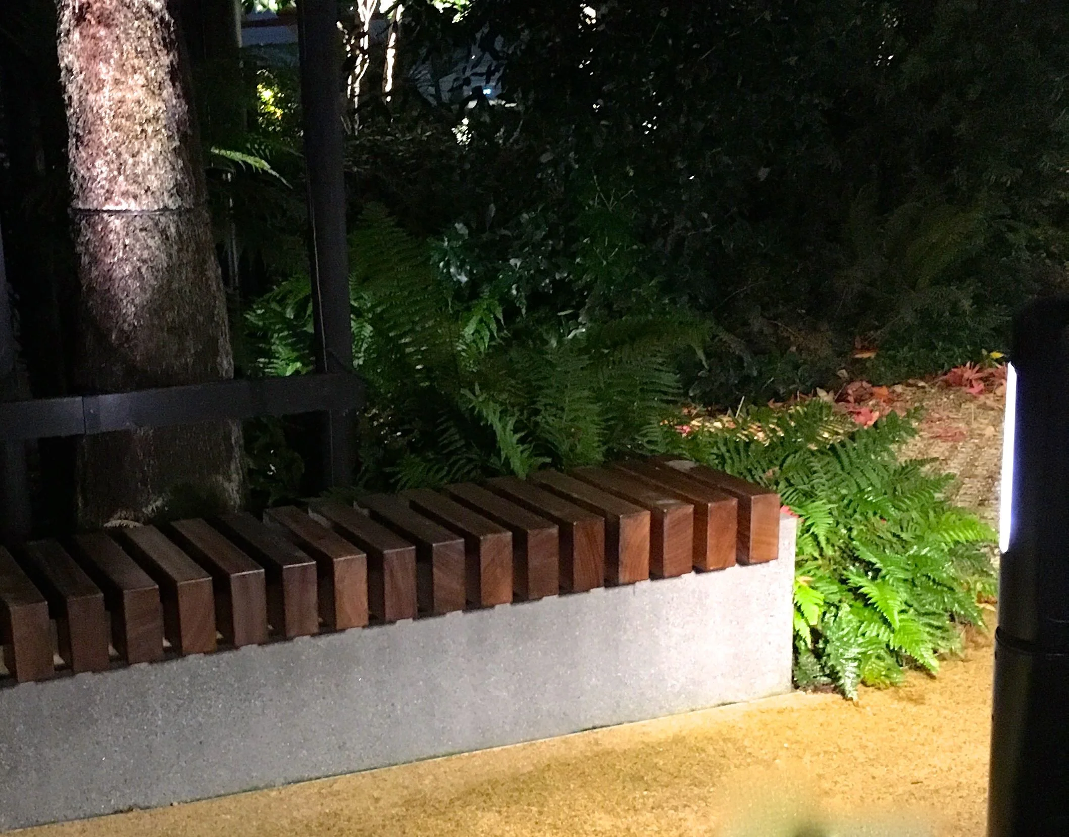 A wooden and concrete bench in the roof garden in crossrail place in Canary Wharf