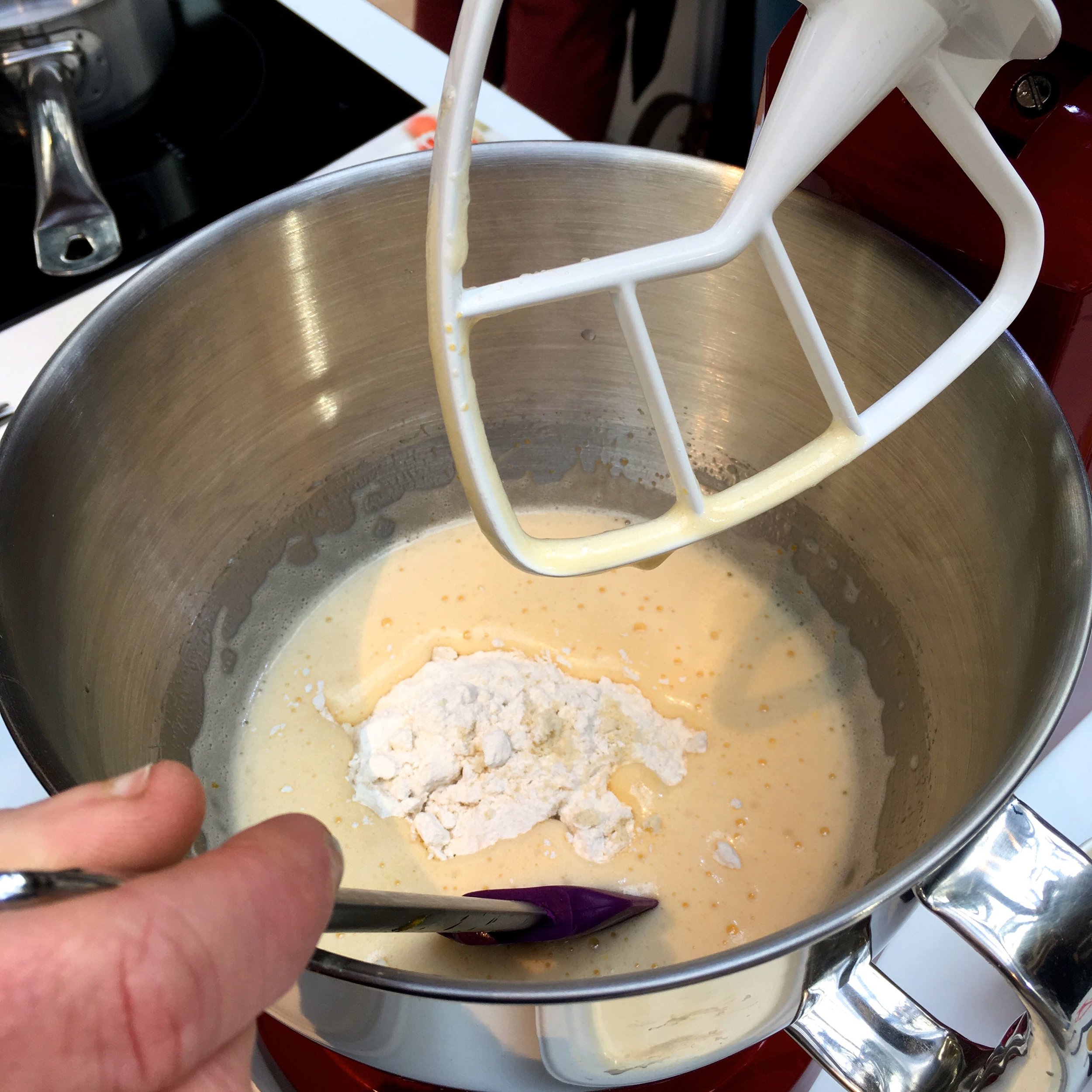 Adding the flour mixture to the eggs and sugar