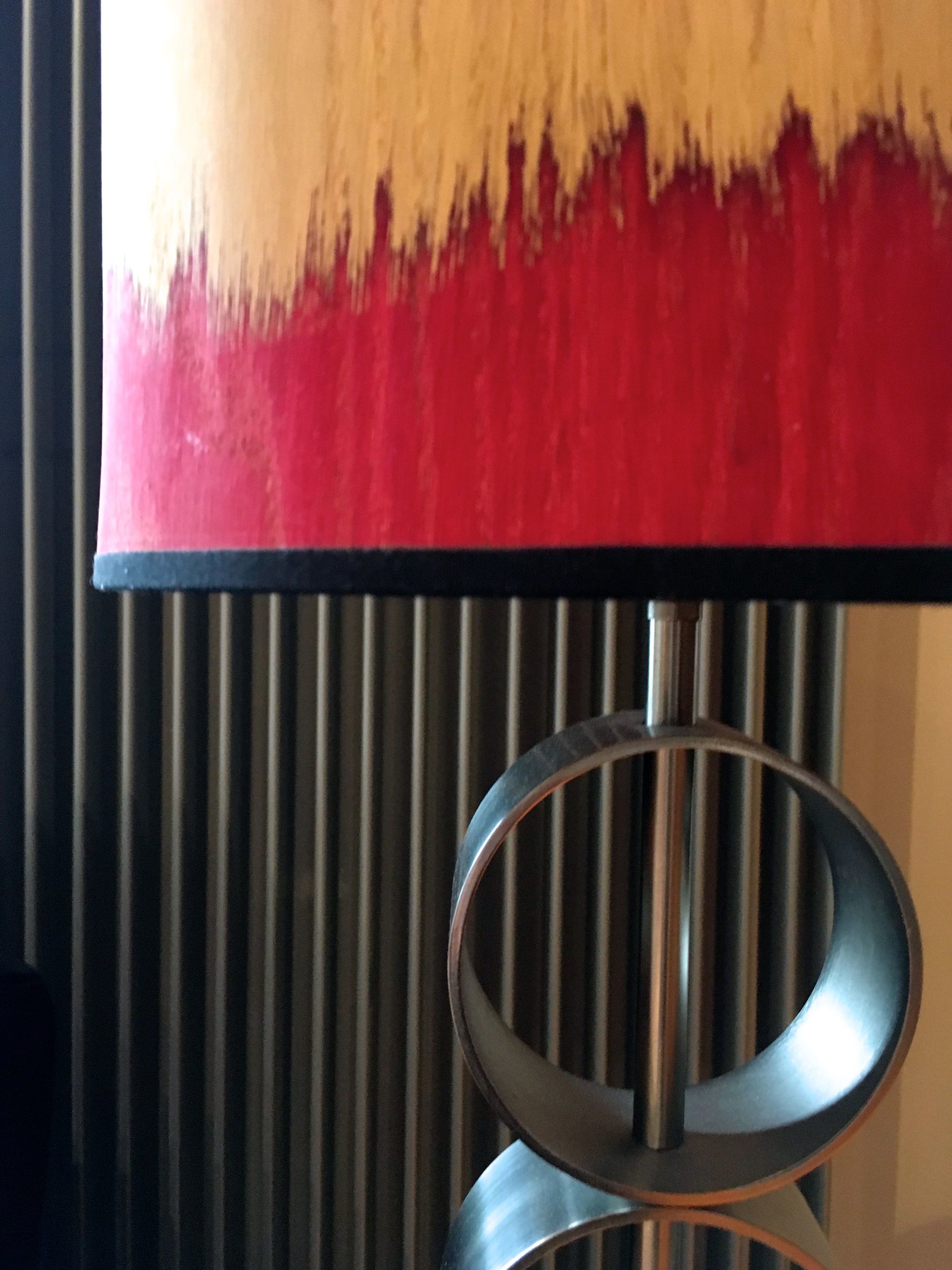 This paper lampshade adds texture with it's feathered pattern and contrasts with the lamp base and the radiator breaking it up nicely #notcompletewithout