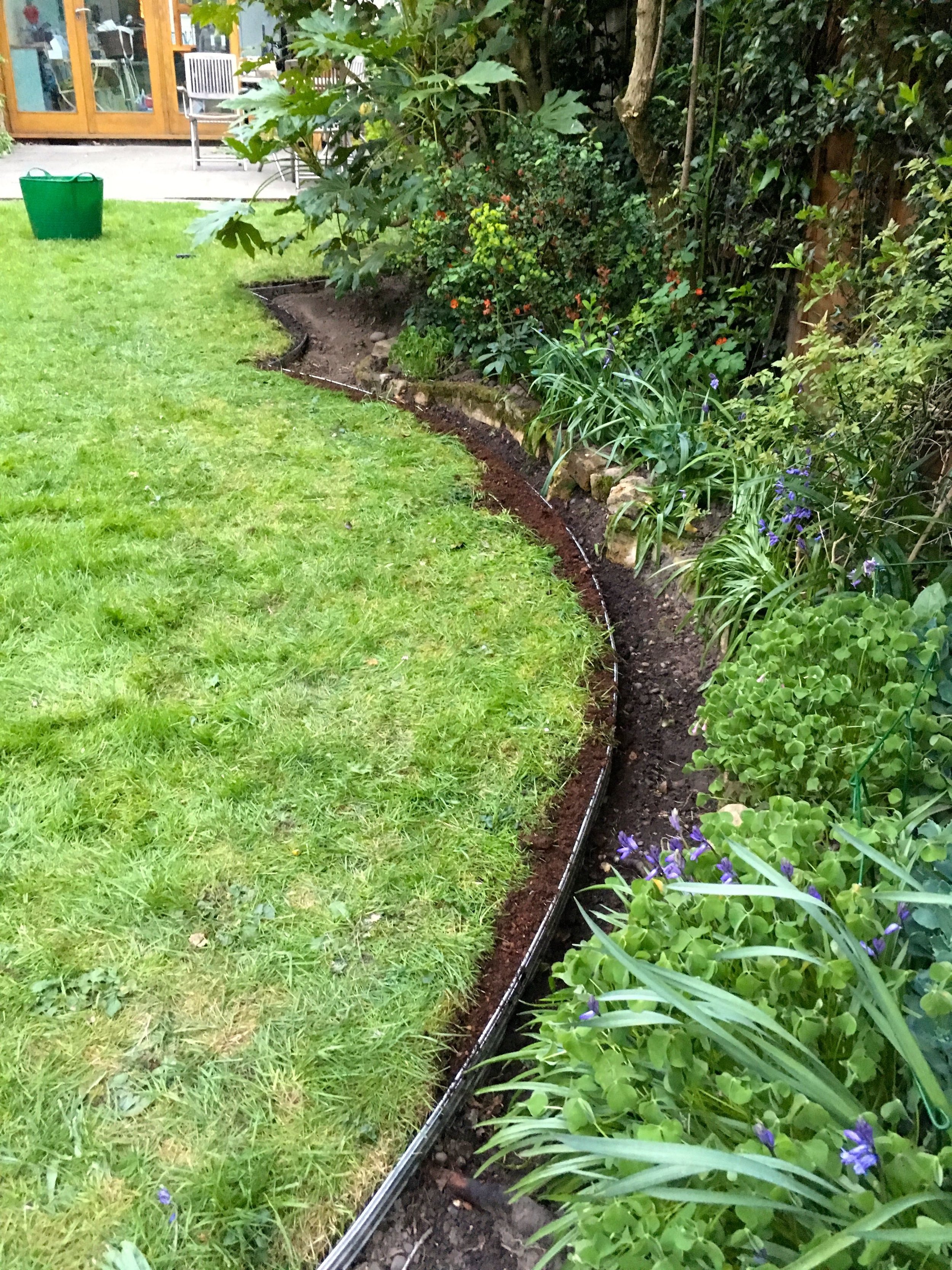 Adding edging, completing circles backfilling and grass seed