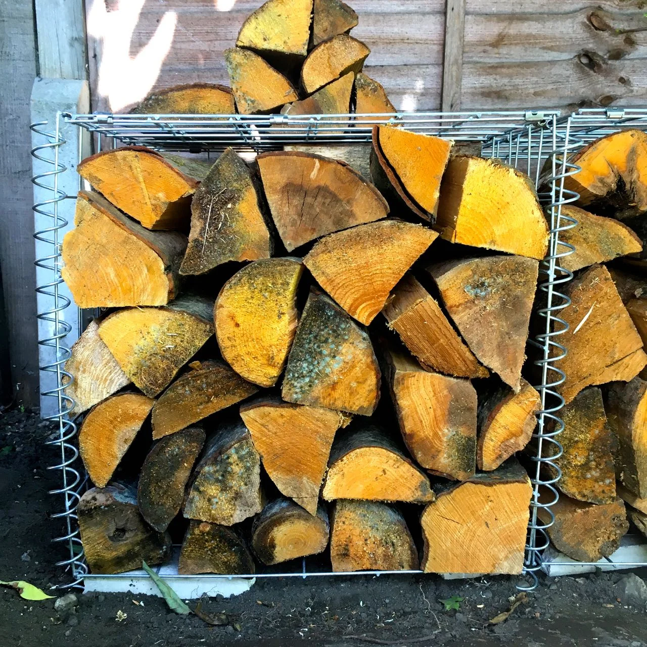 Storing logs in our gabion baskets — Life at 139a