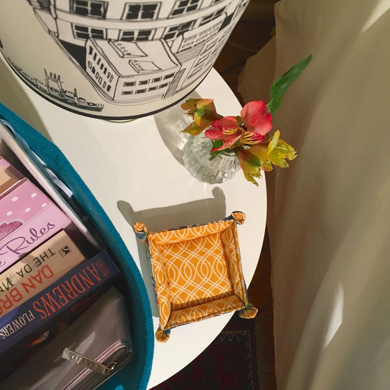 A posy of flowers, bedside lamp and a tray to put trinkets in