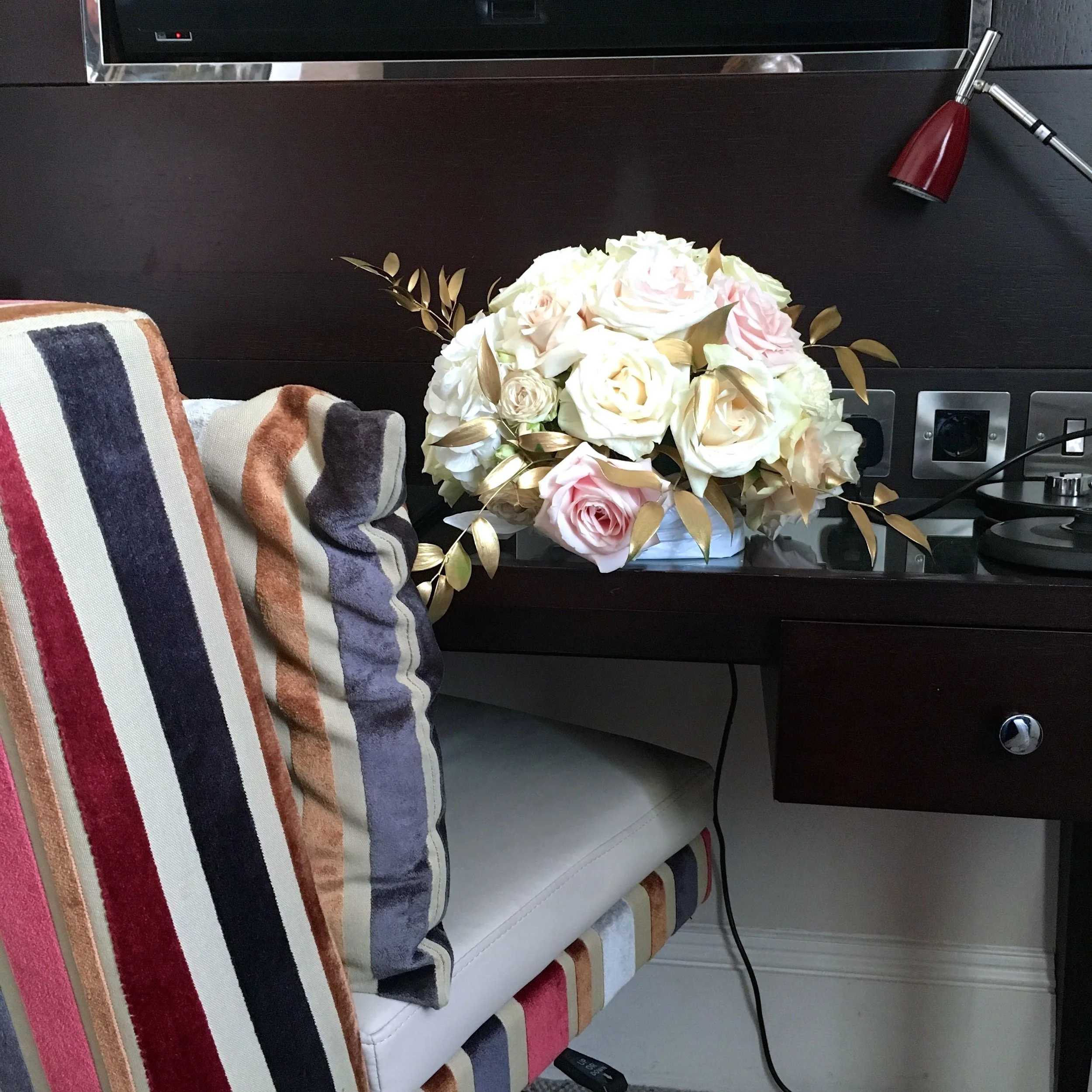 A desk an upholstered chair