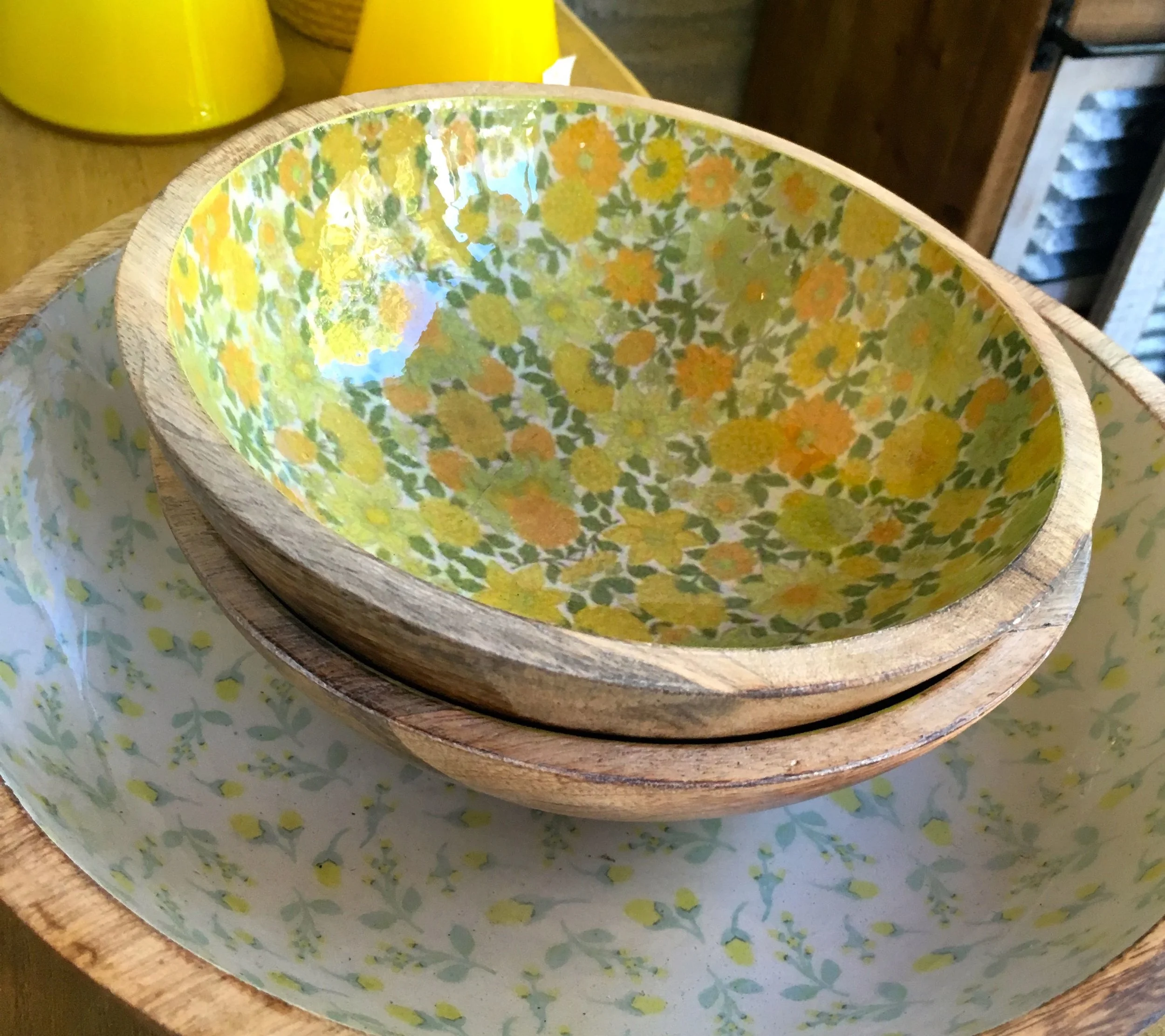 Wooden bowls underneath with a patterned interior