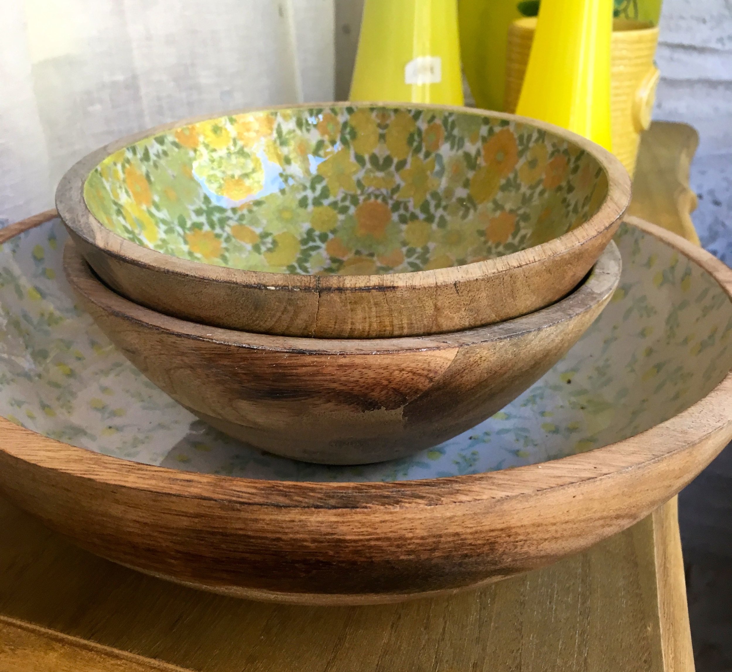 A sideview of the wooden and patterned bowls