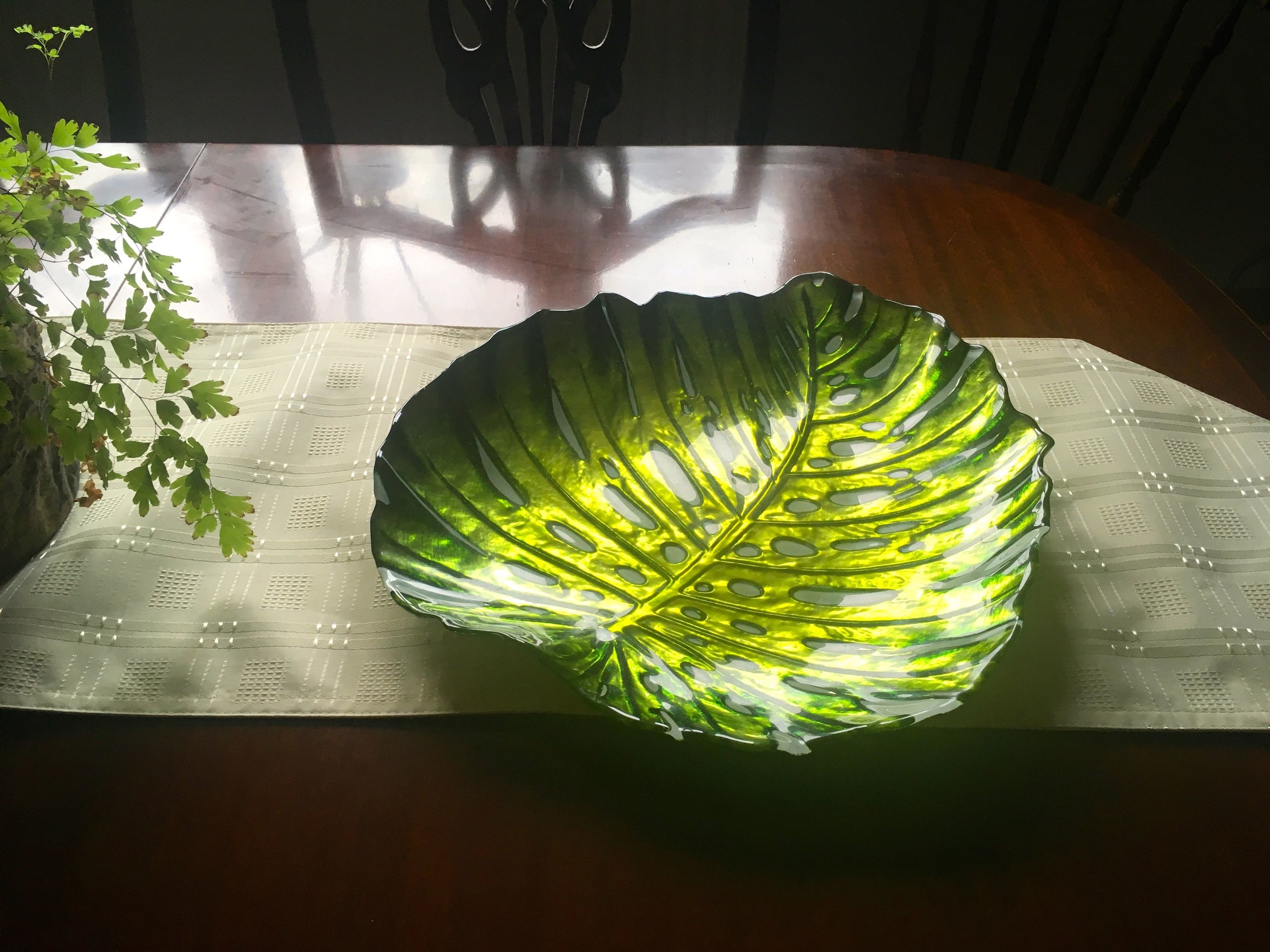 A leaf plate and a polished mahogany table