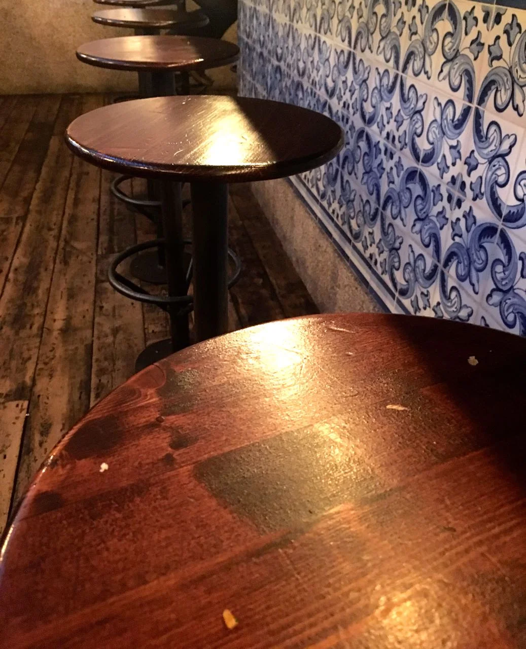 Stools lined up against the tile clad counter