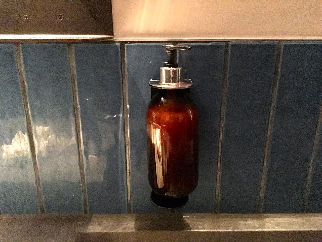 A closer look at the tiles and soap dispensers