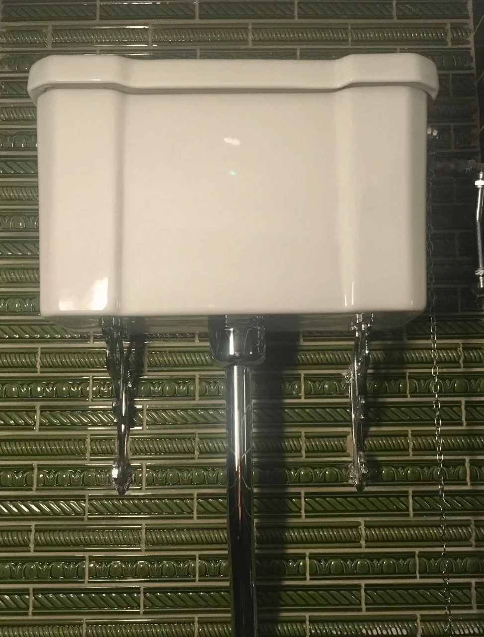 a high cistern and decorative edging tiles