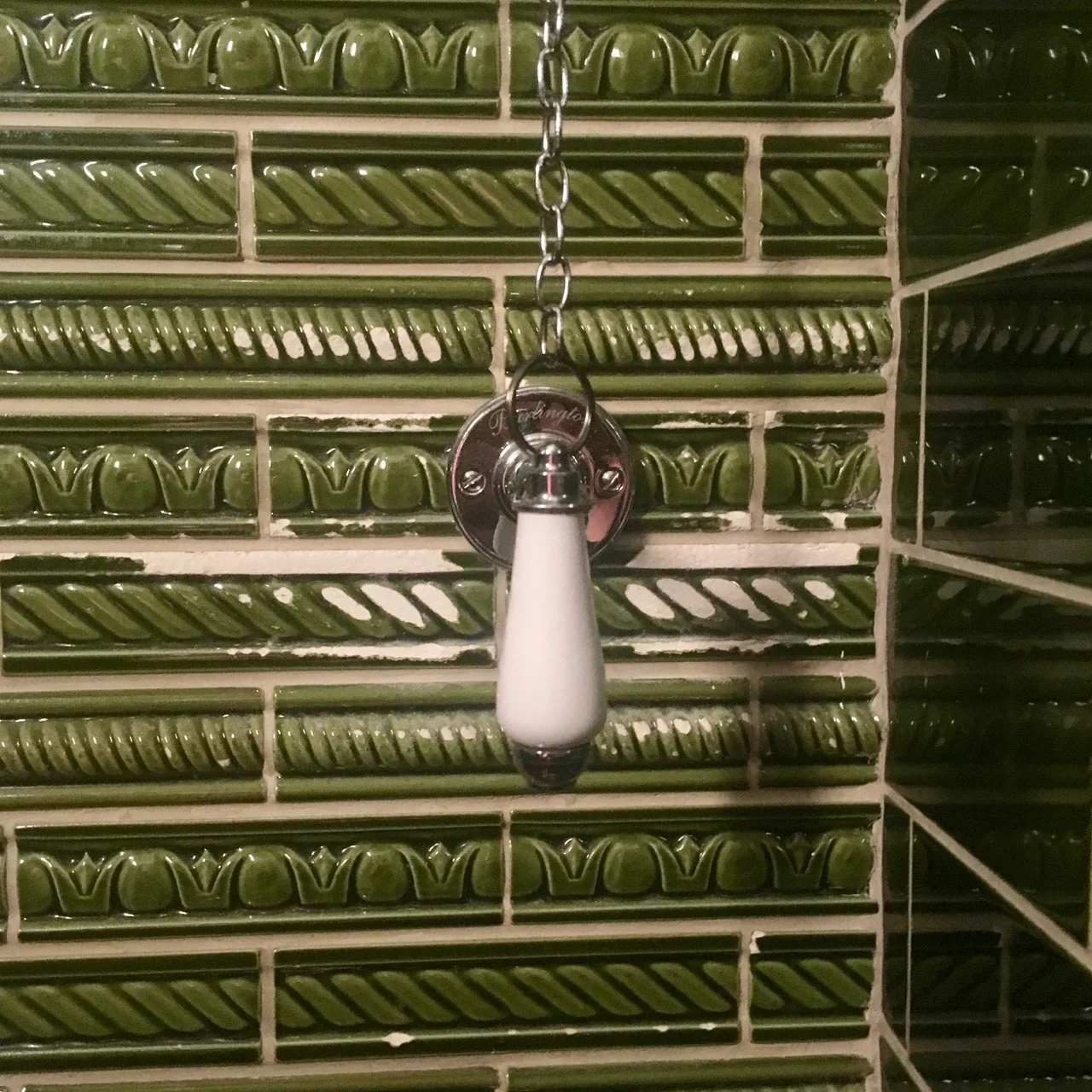 patterned tiles with some wear by the chain pull