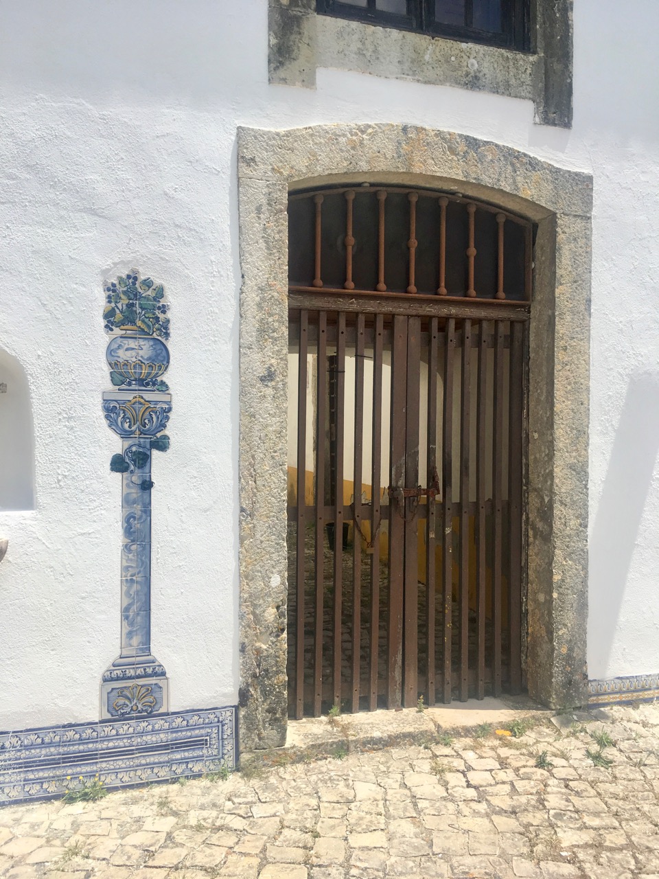 Beautifully stylish Azulejo tiles, and a rather functional gate by comparison.