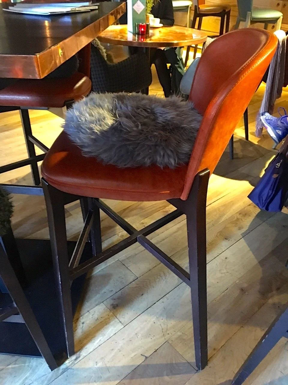 A high bar stool and cosy cushion