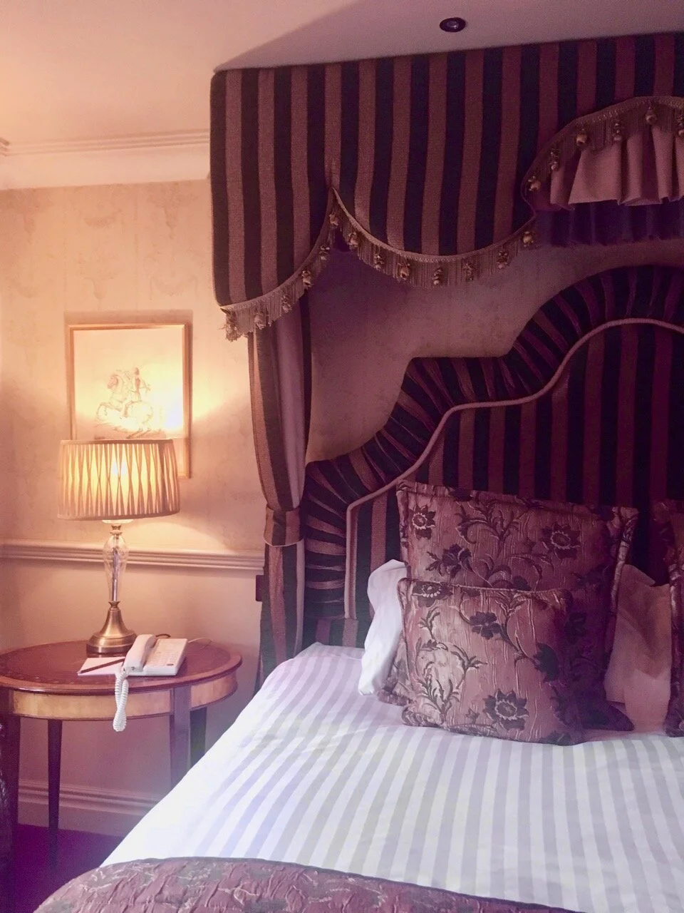 a grand bed to match the feel of the room