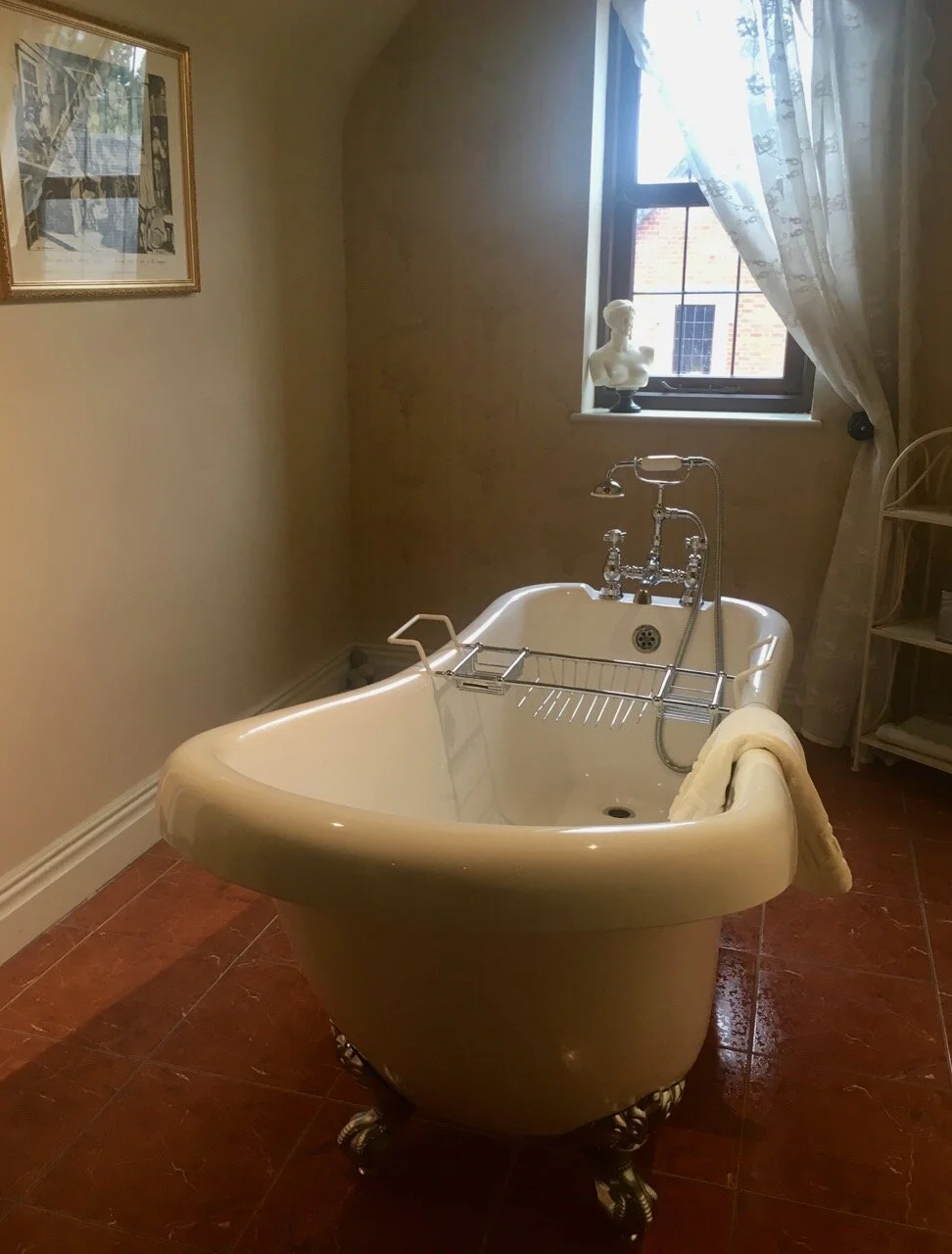 Up the spiral stairs we discovered the roll top bath