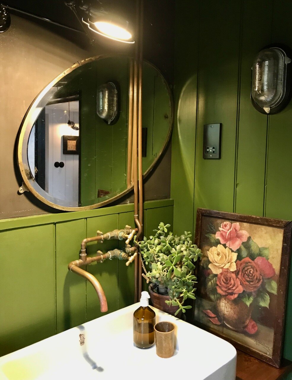 a sink, panelling a mirror and a picture