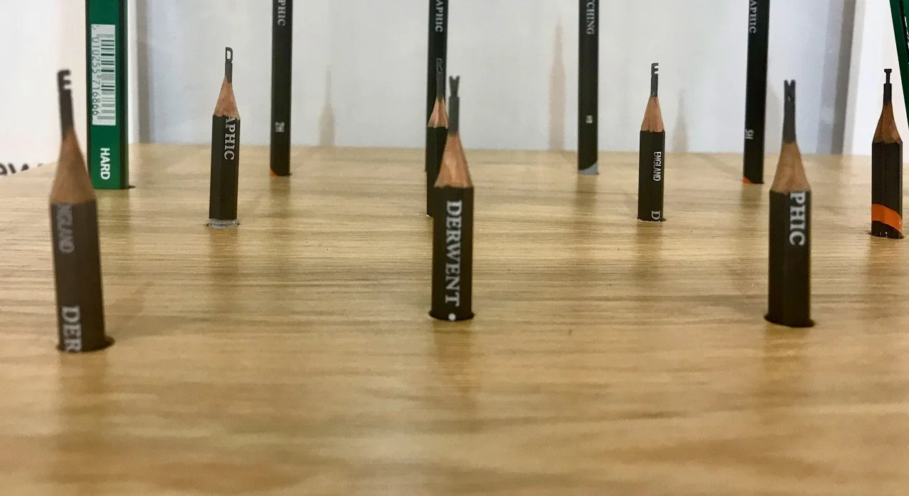 pencil stubs with carvings made out of the lead  - the letters here spell Derwent
