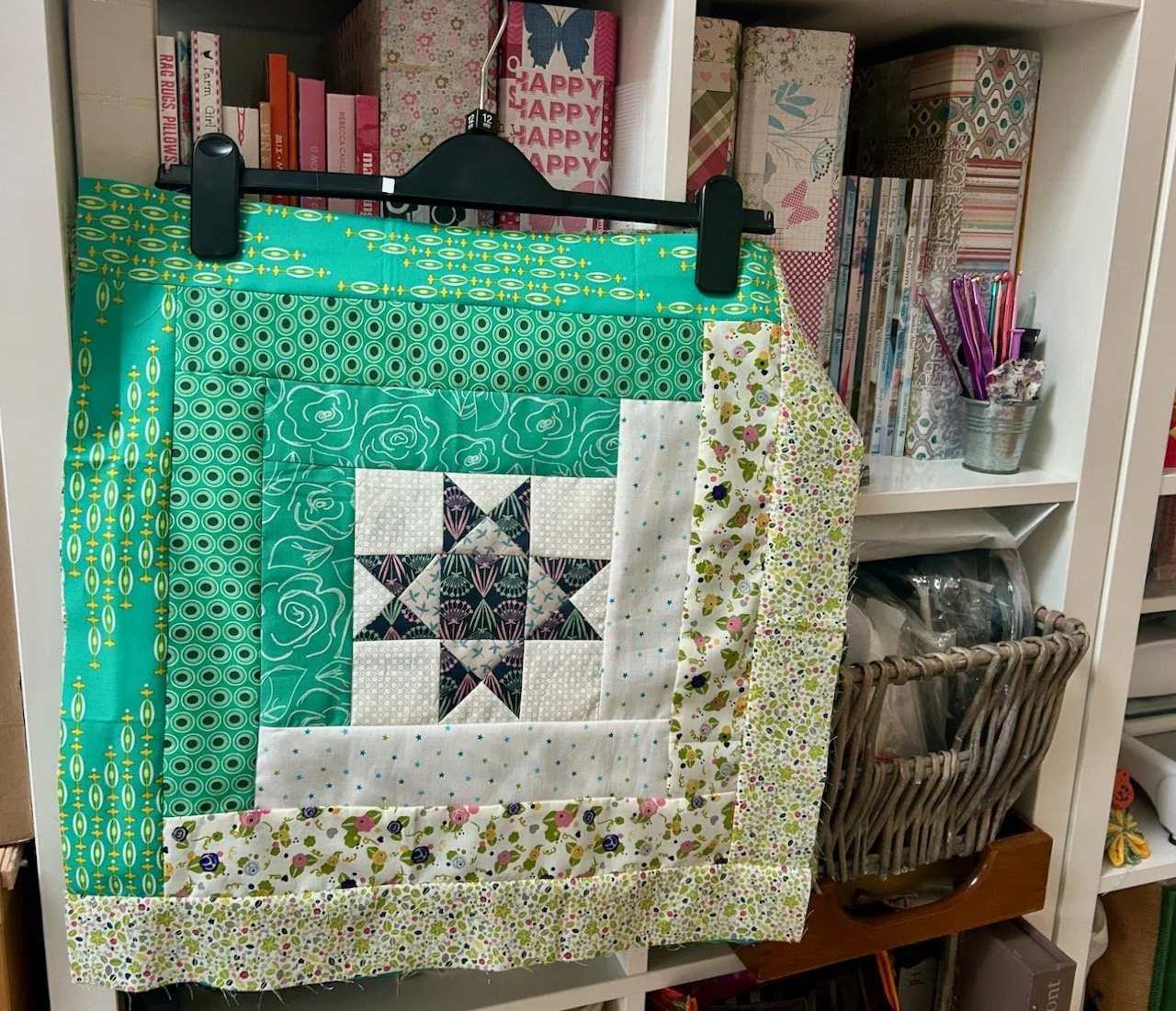 the completed block hanging with the others on my bookcase