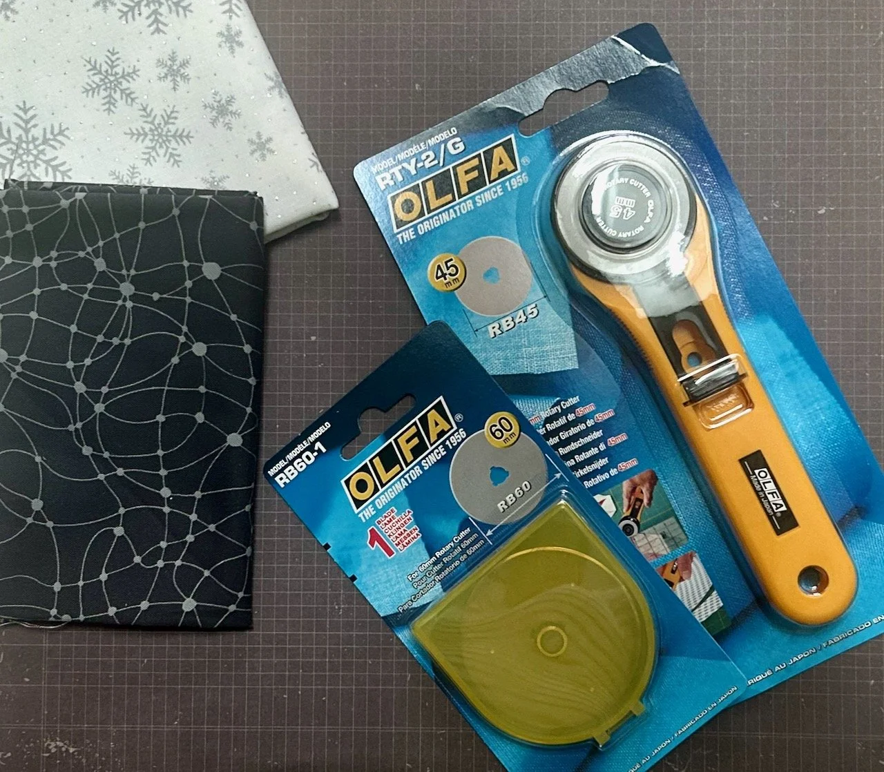 two fat quarters, a replacement blade and a new rotary cutter