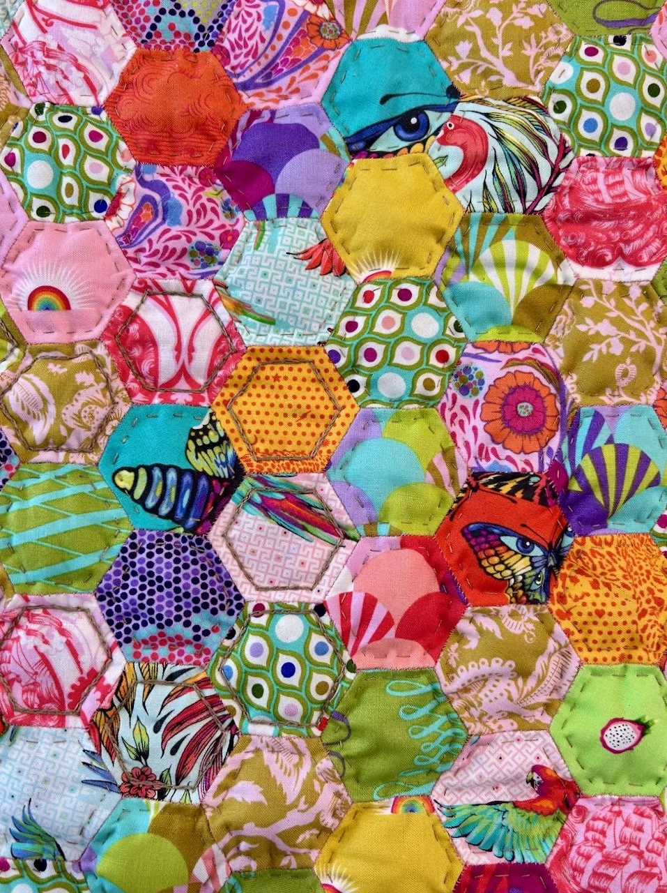 A closer look at part of the hexies on the front with hand quilting - running stitch on most, chain stitch on some