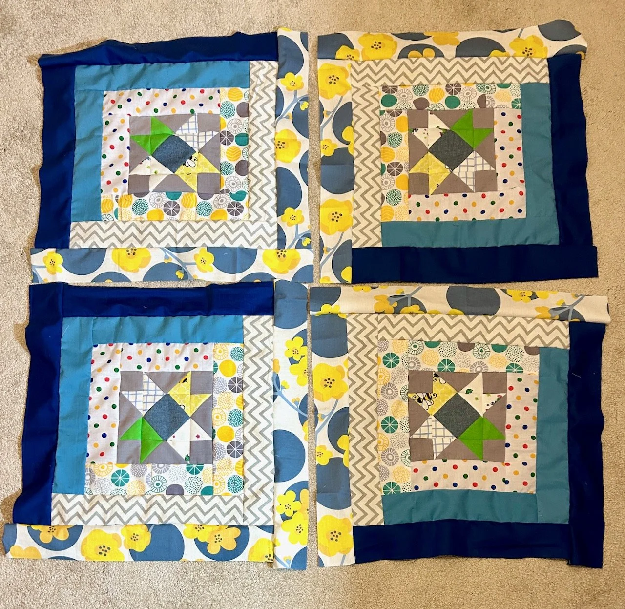 The four blocks now with the borders sewn on