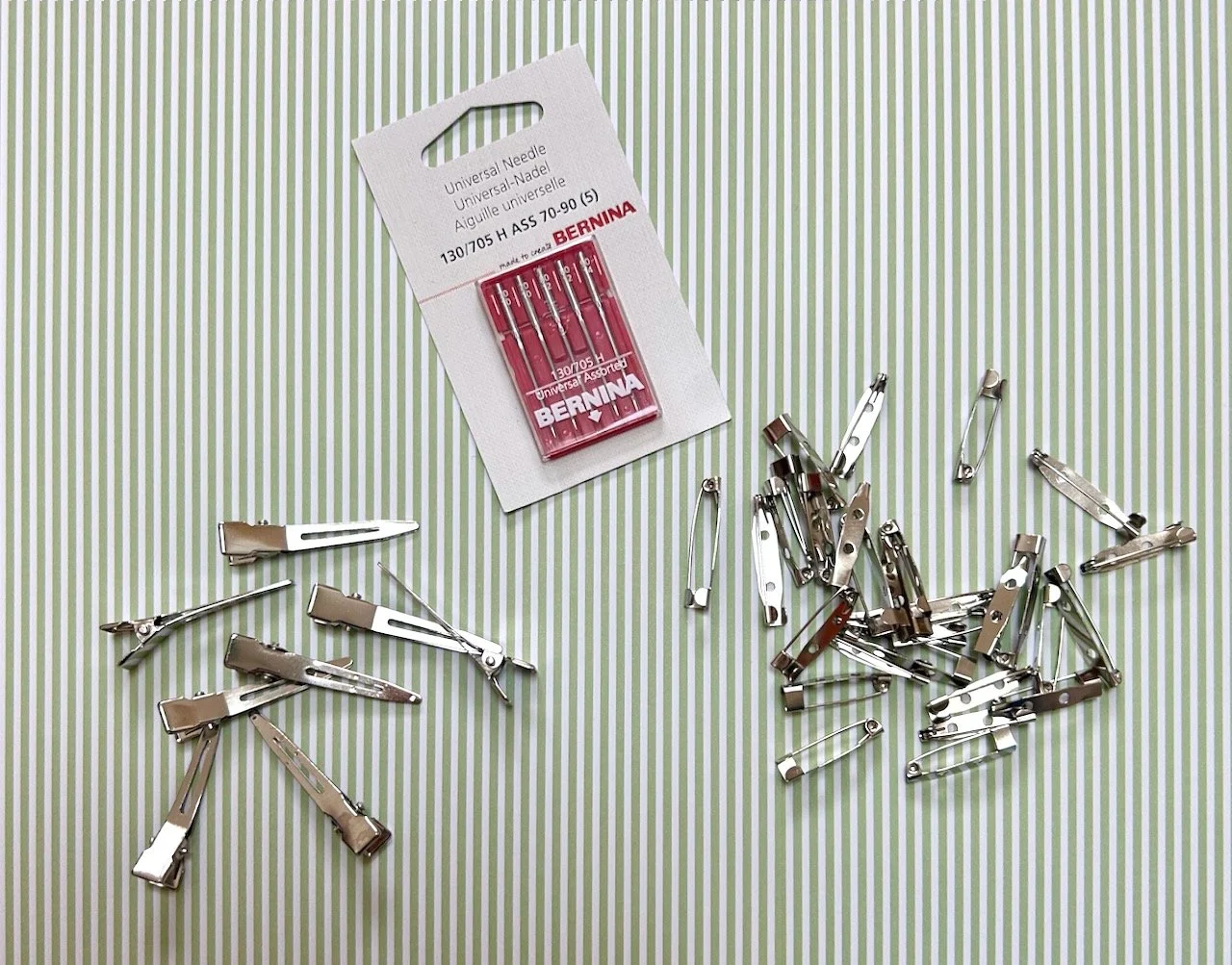 hair clip backs, bernina sewing machine needles and two sizes of brooch backs