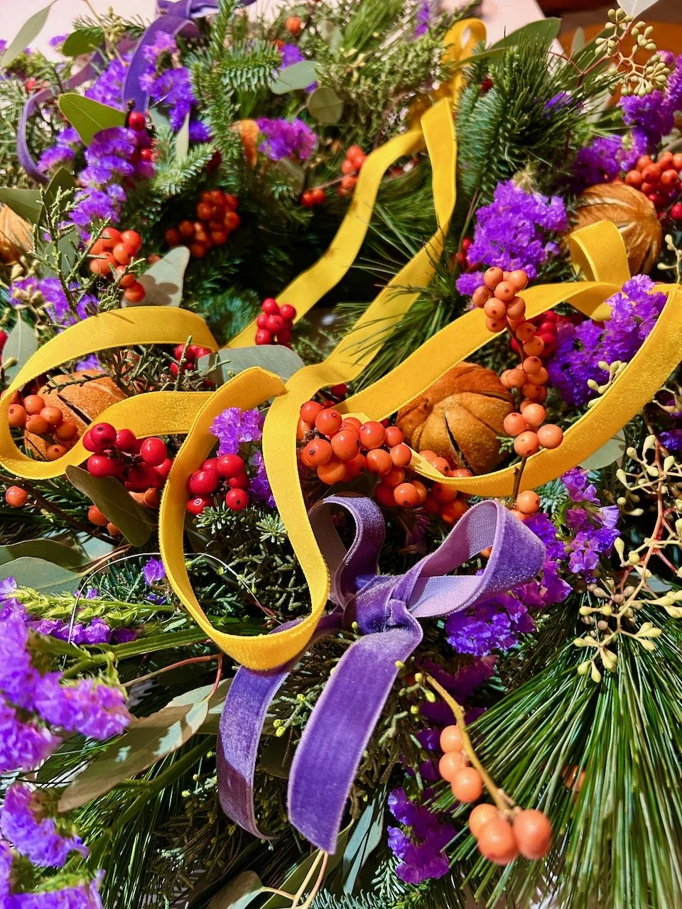 A close up of my Christmas wreath with its lavender and mustard velvet ribbons