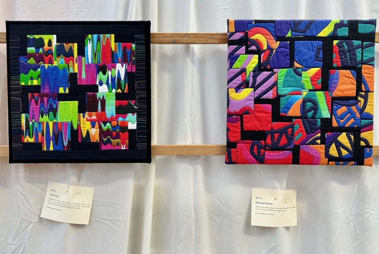 THE LITTLE BOXES AND DANCING SQUARES QUILTS DISPLAYED SIDE BY SIDE AT THE QUILT SHOW