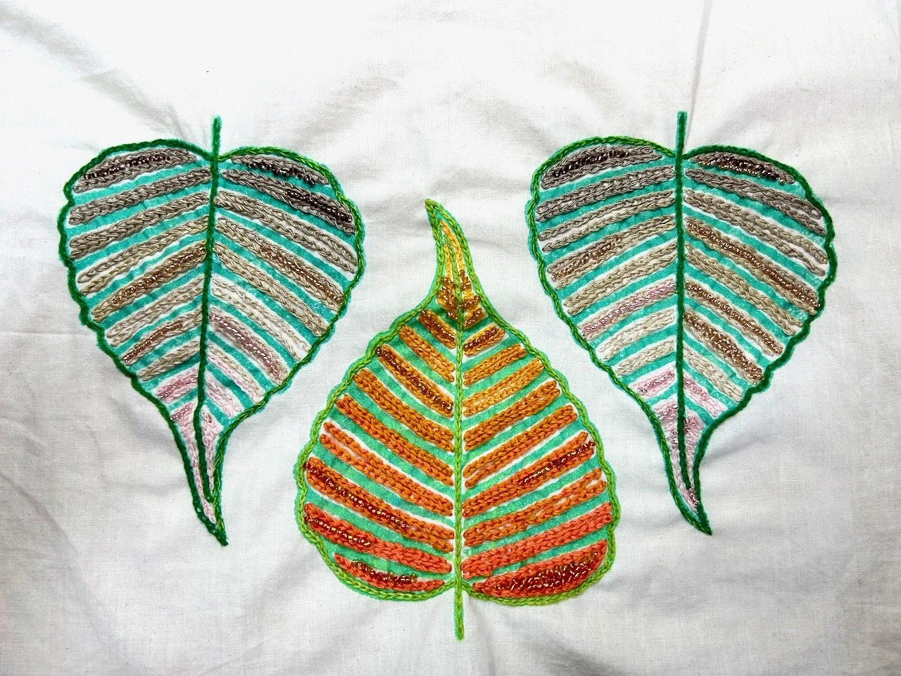 The same three leaves, now with added beads in some of the gaps - the beads follow the colours of the threads