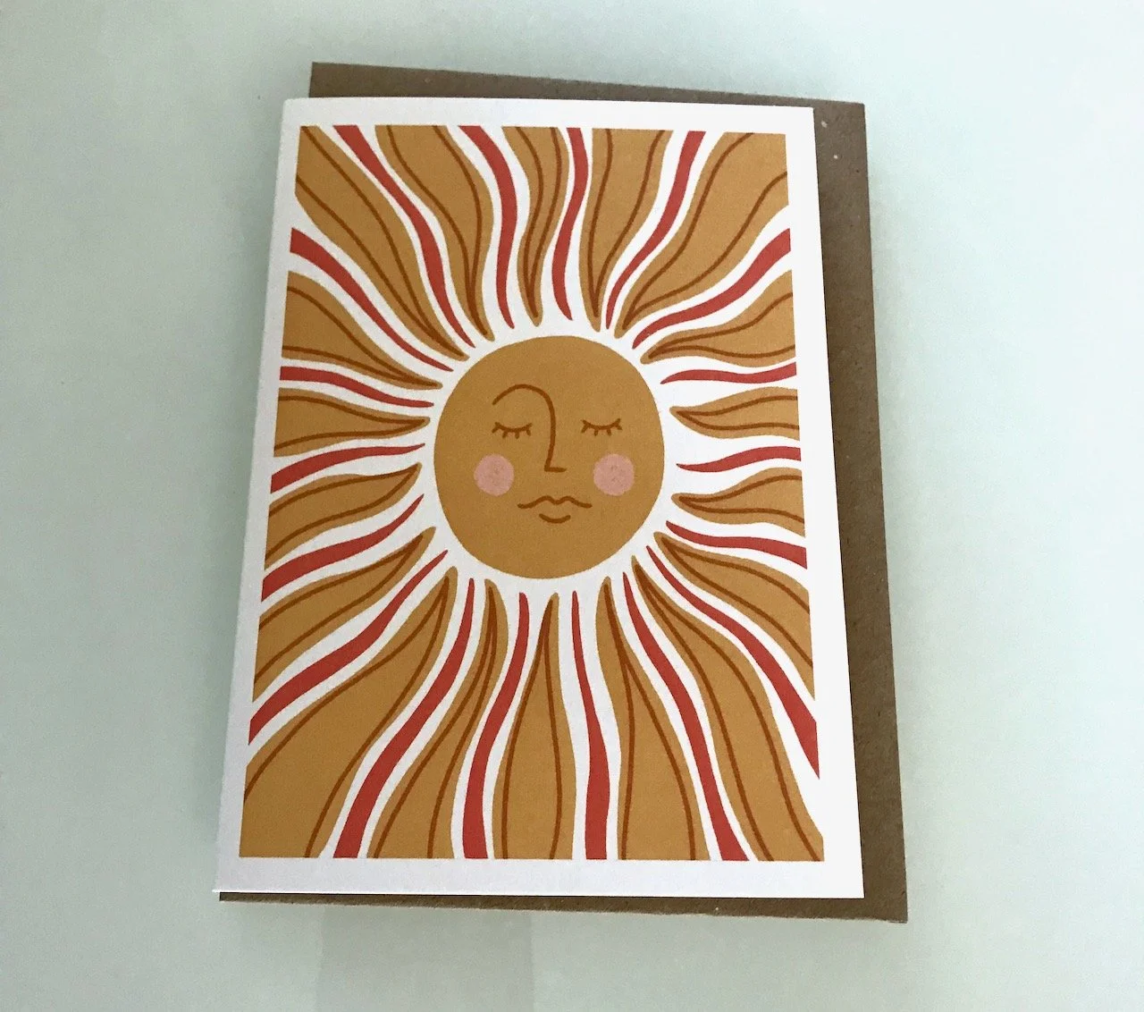 a shimmering sun in gold red and white